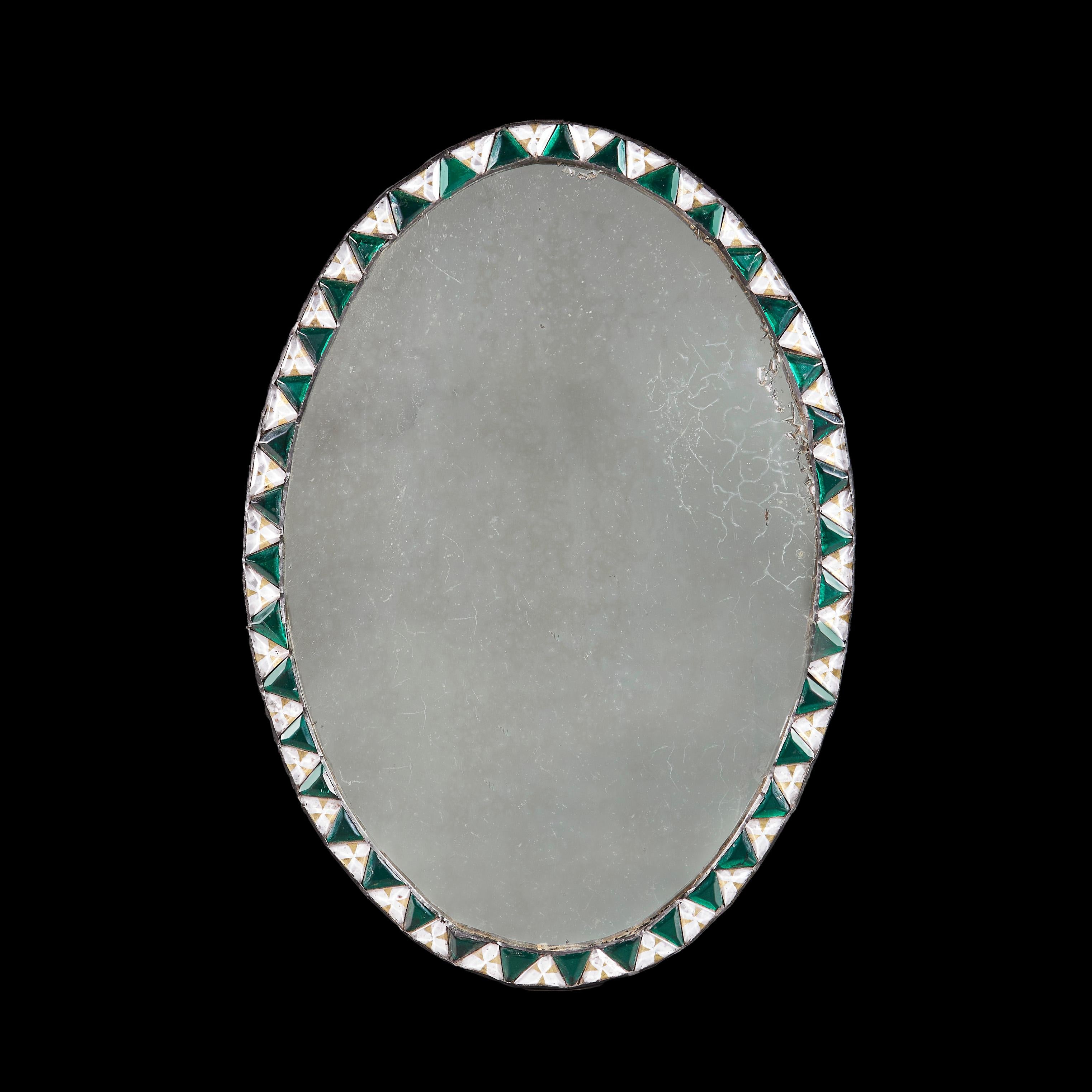 Ireland, circa 1900

An early twentieth century oval mirror with alternating losenges of cut glass beads in green and clear glass with heavily oxidised mercury mirror plate.

Height 60.00cm
Width 42.00cm.