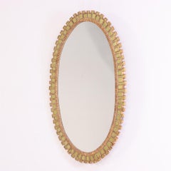 Miroir ovale à la manière de Line Vautrin.