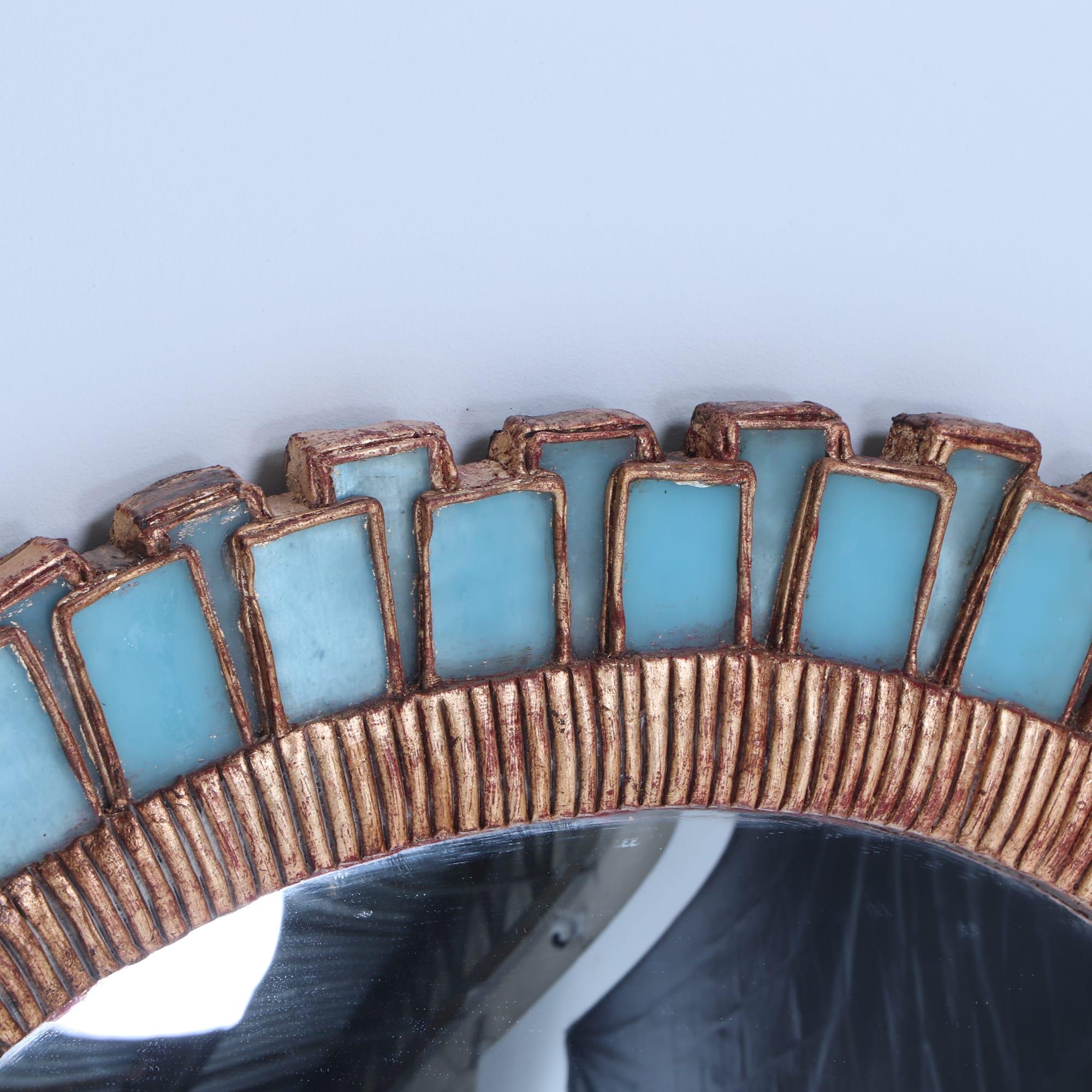 An oval mirror made of gilt resin and blue glass in the manner of Line Vautrin.  In Excellent Condition For Sale In Philadelphia, PA