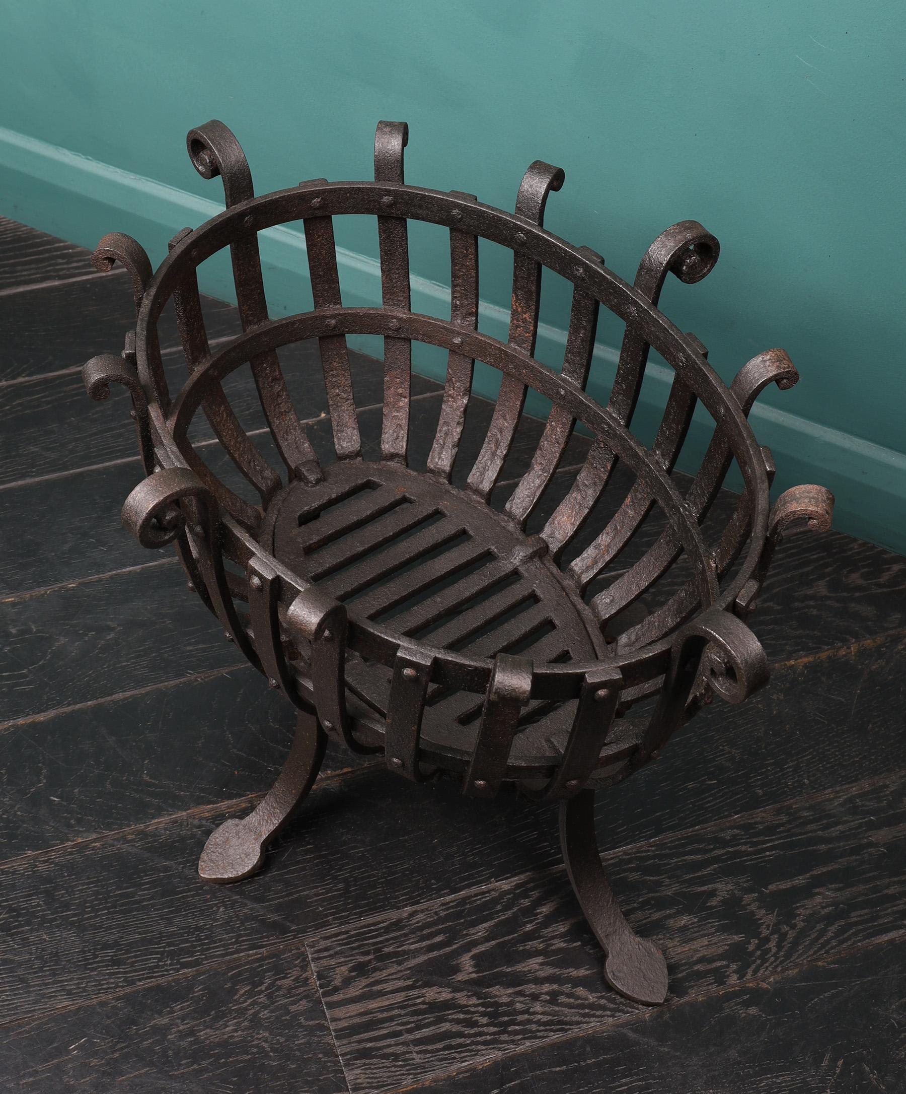 An oval wrought fireplace fire basket brazier. The blacksmith-made fire basket of rivet-work construction with scroll finials supported on spear feet. Perfect for a garden brazier. Wax finish.
Height of burning area: 6″
Circa 19th century