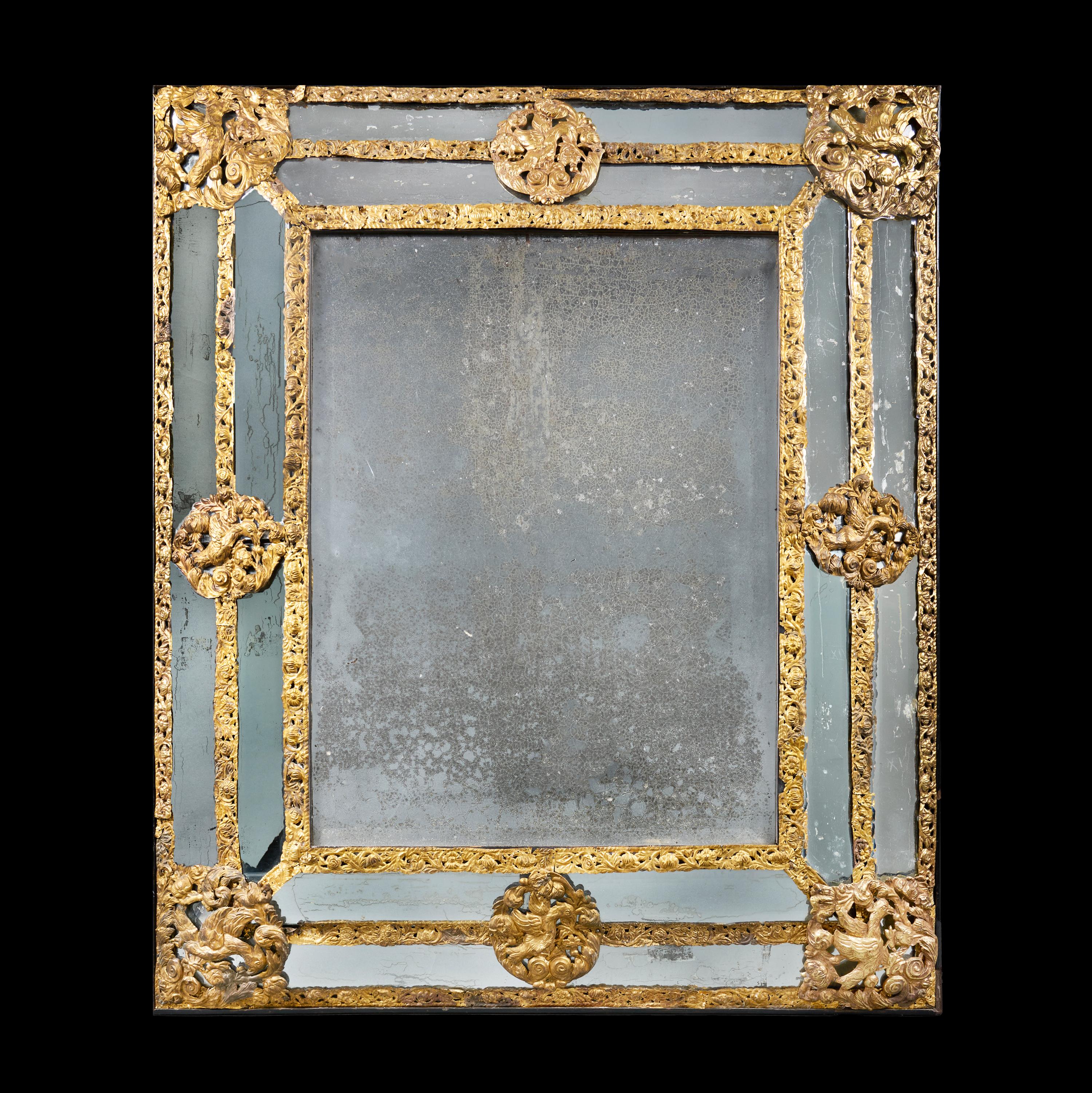 France, circa 1850

A large mid 19th century brass repoussé pier mirror with mirrored and bevelled glass border plates, foliate decoration throughout with birds to the margins, retaining the original mirror plate.

Height 125.00cm 

Width 107.00cm
