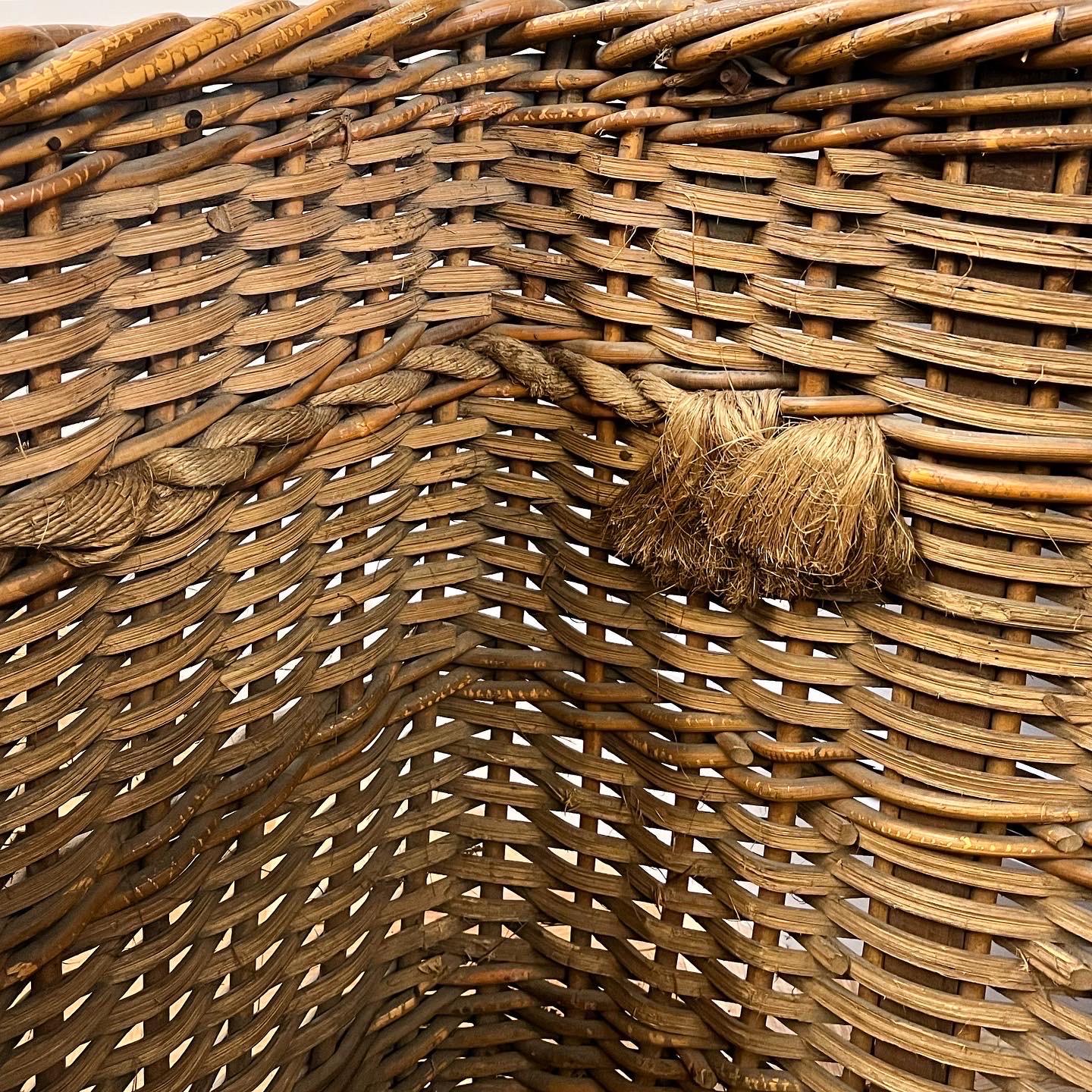 An overscale wicker log basket with heavy rope handles interwoven to both sides, remnants of painted marks to front and in exceptionally good condition.

English, Early Nineteenth Century

H 66.5 x W 105 x D 70 cms

