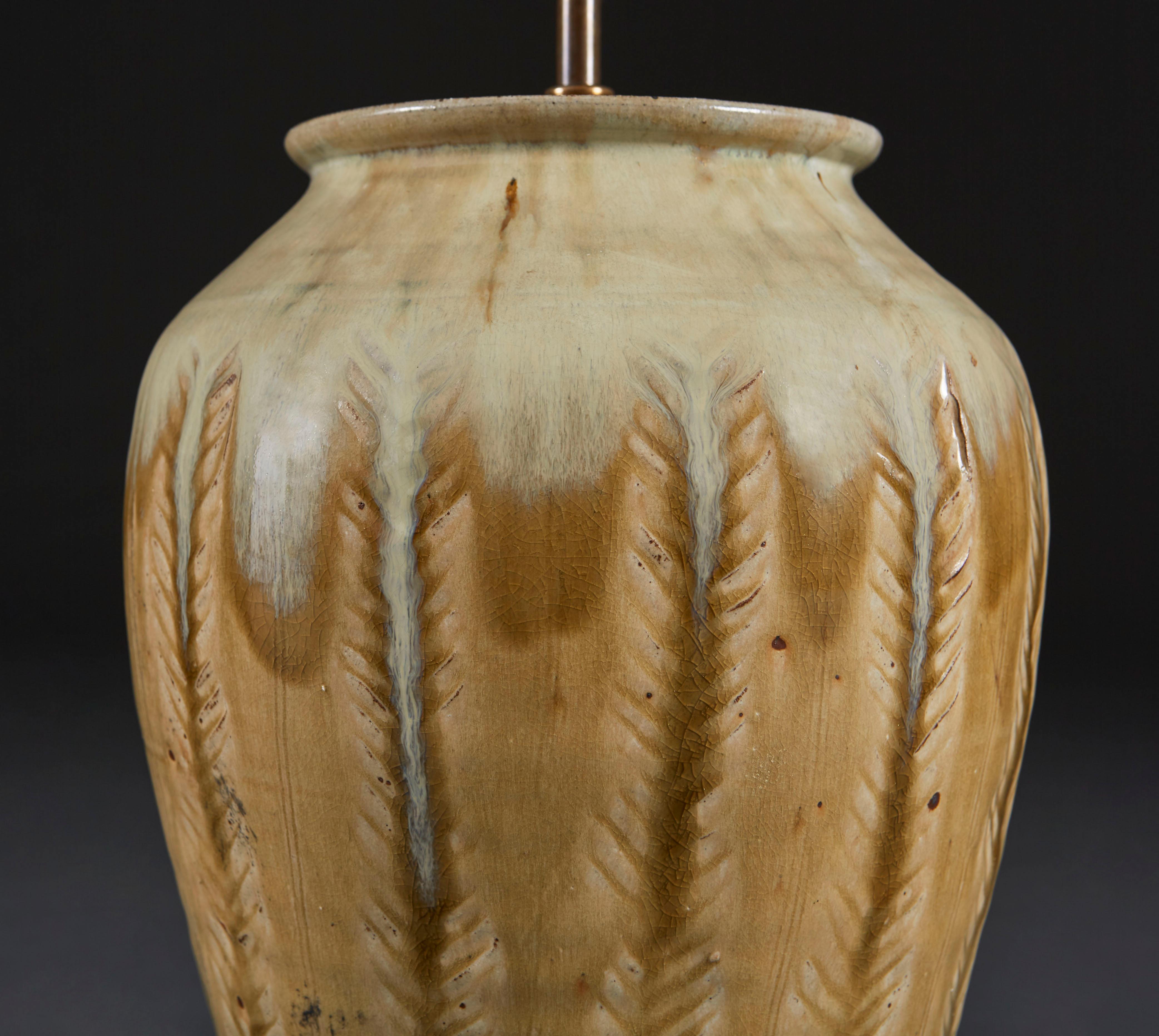 An over scale art pottery vase, the stoneware impressed with feathers and finished with a subtle pale blue drip glaze to the upper portion. By Mike Dodd (b.1943).

Please note: lampshade not included.

Currently wired for the UK.