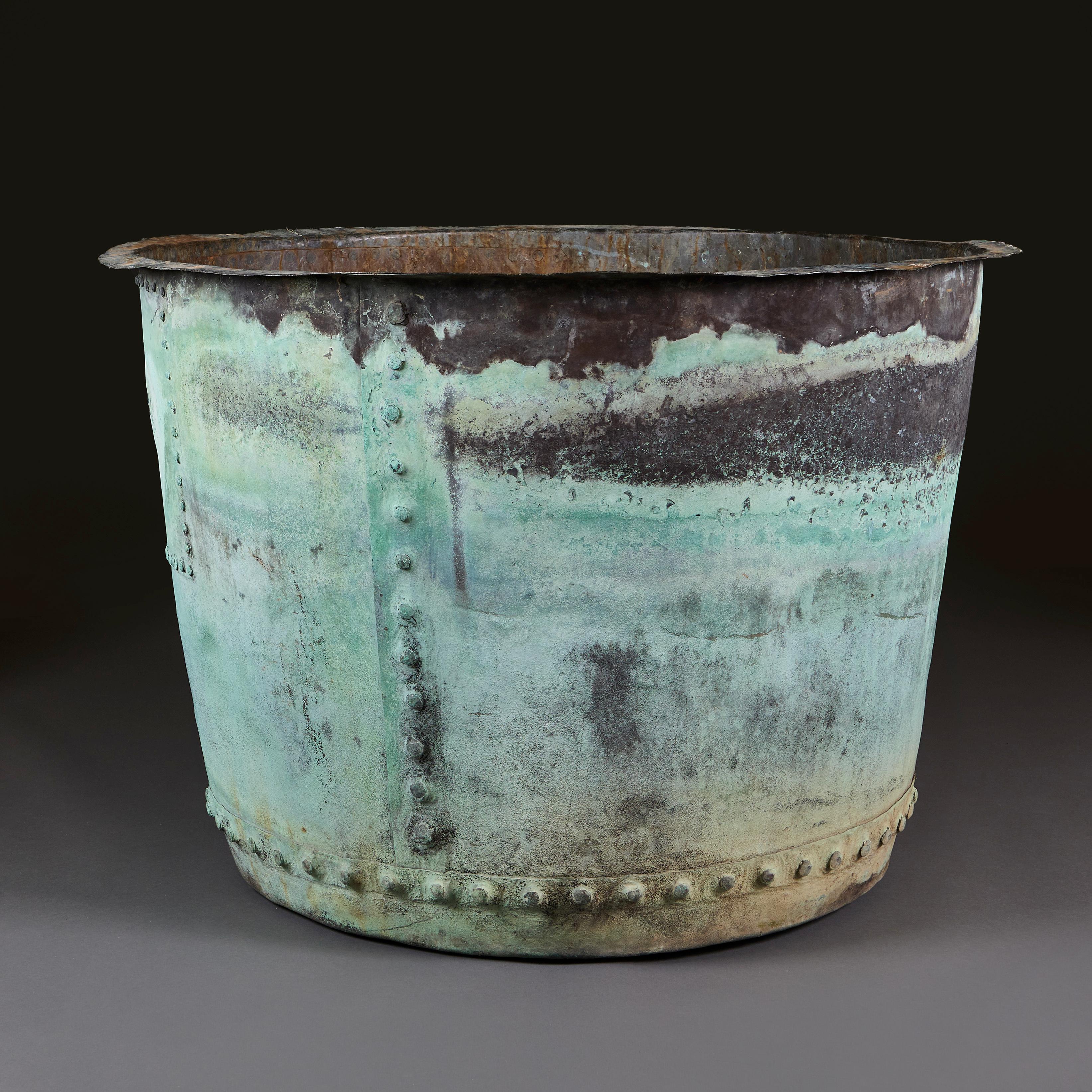 England, circa 1880

A very large late 19th century copper planter of circular form, with veridigris patination throughout, with circular rivits to the joins.

Measures: Height 72.00cm
Diameter 102.00cm.