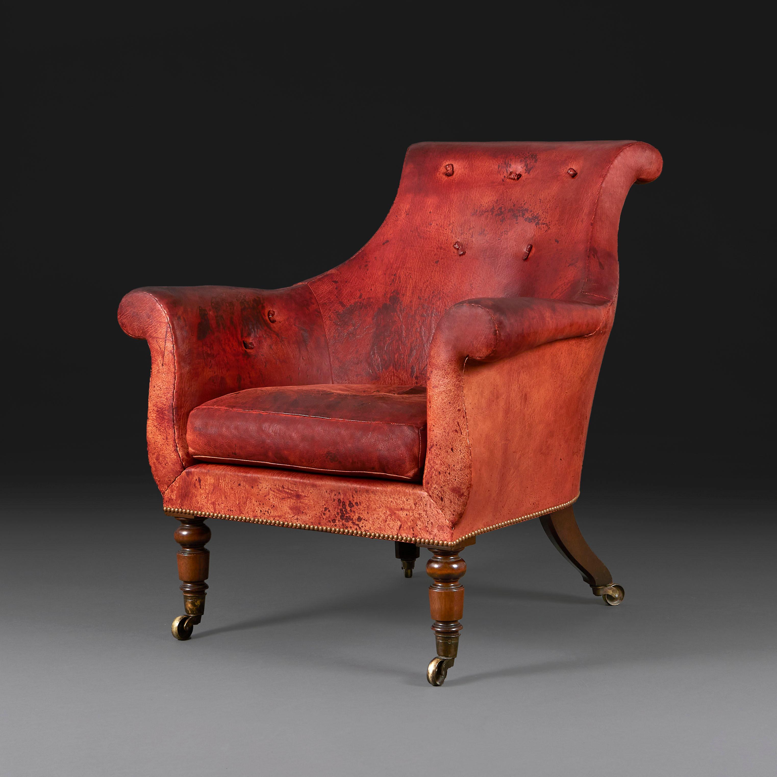 England, 20th century

A William IV style twentieth century library armchair of large scale, with exceptional red patinated leather. The back deep buttoned with tufts, seat cushion, the frame constructed from stained beechwood, with turned legs