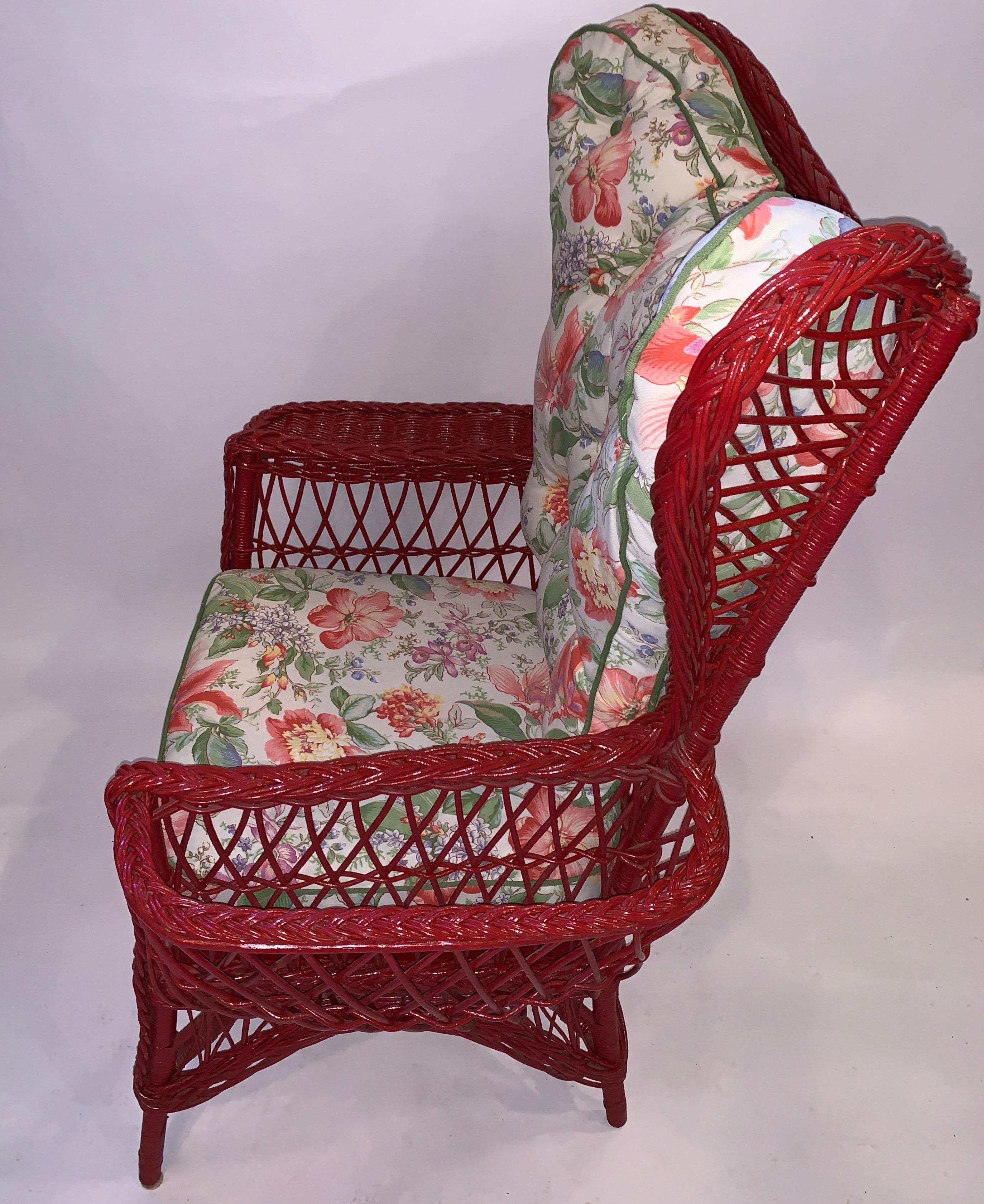 An exceptional oversized Bar Harbor style wing chair, C. 1900, American with oversized exaggerated curved wings, a wide arm and magazine pocket. It is hand woven with all new cushioning and contemporary upholstering.This is one of four complimentary