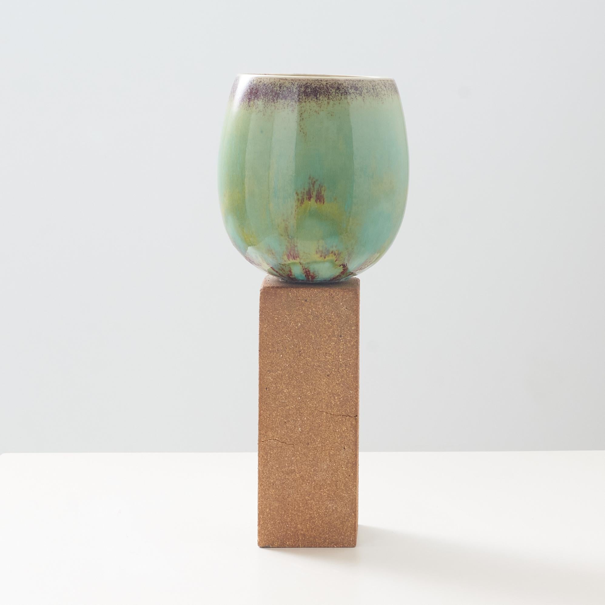 An ovoid vase with green glaze on tall stone base. Retains Gustavsberg sticker. Signed Stig L. 

3 hairline cracks in the base.