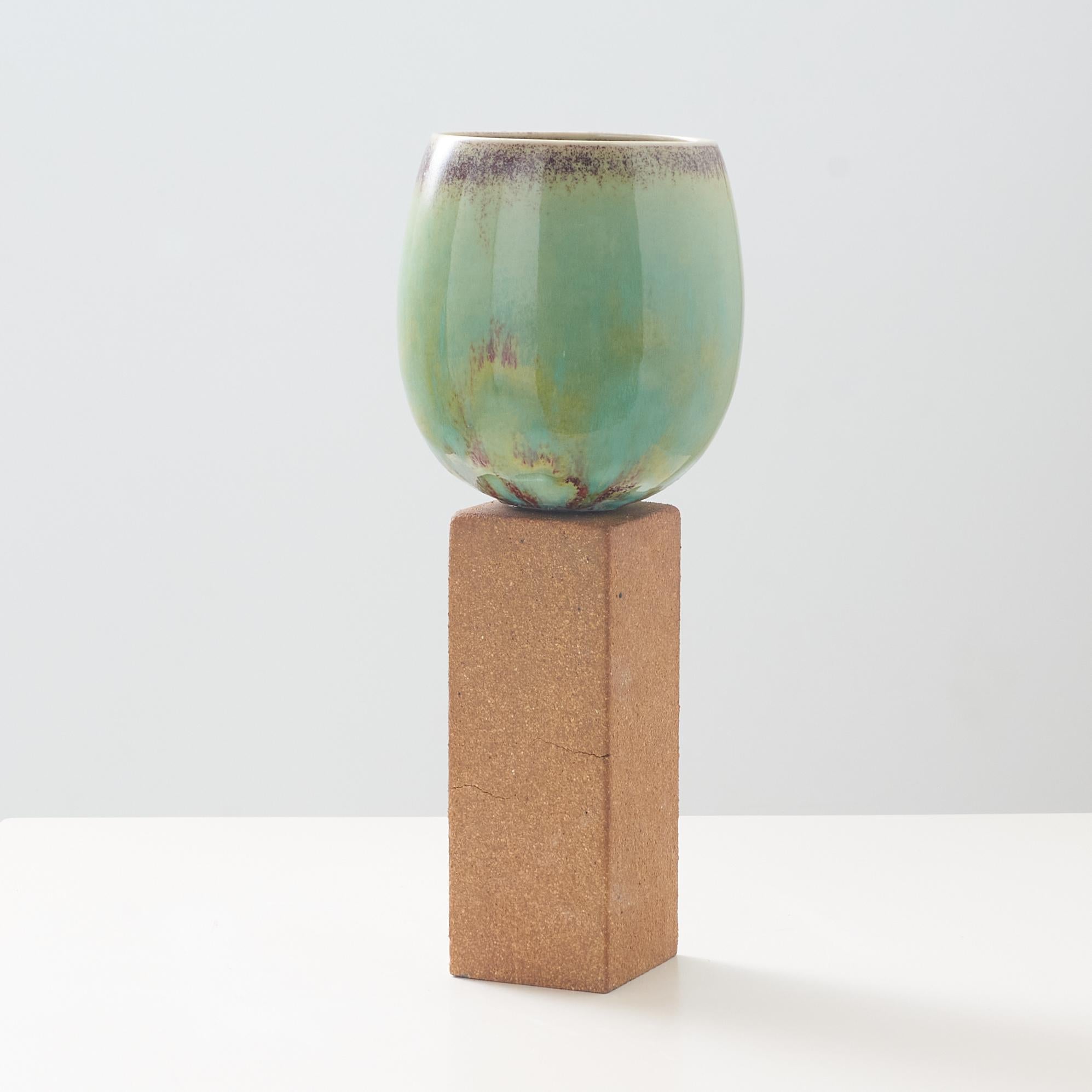 Modern An ovoid vase with green glaze on tall stone base by Stig Lindberg