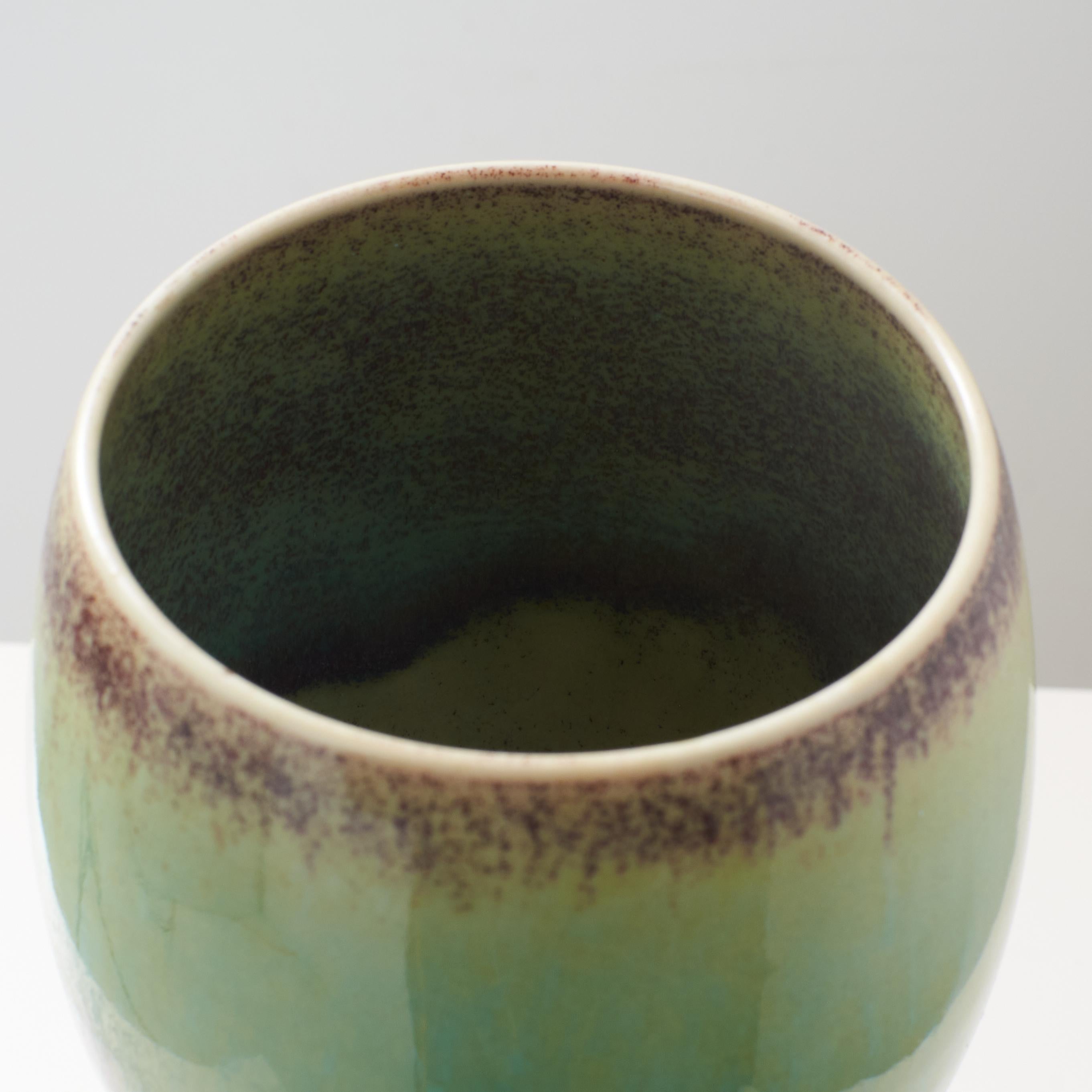 Stoneware An ovoid vase with green glaze on tall stone base by Stig Lindberg