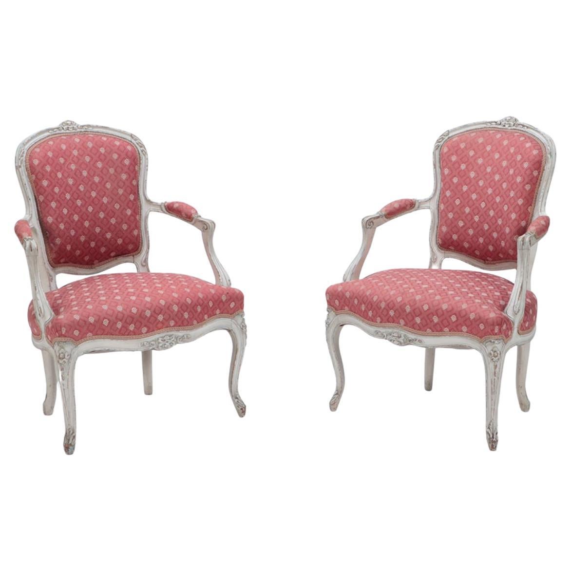 An pair of painted and carved  French Louis XV style open arm chairs circa 1900. For Sale