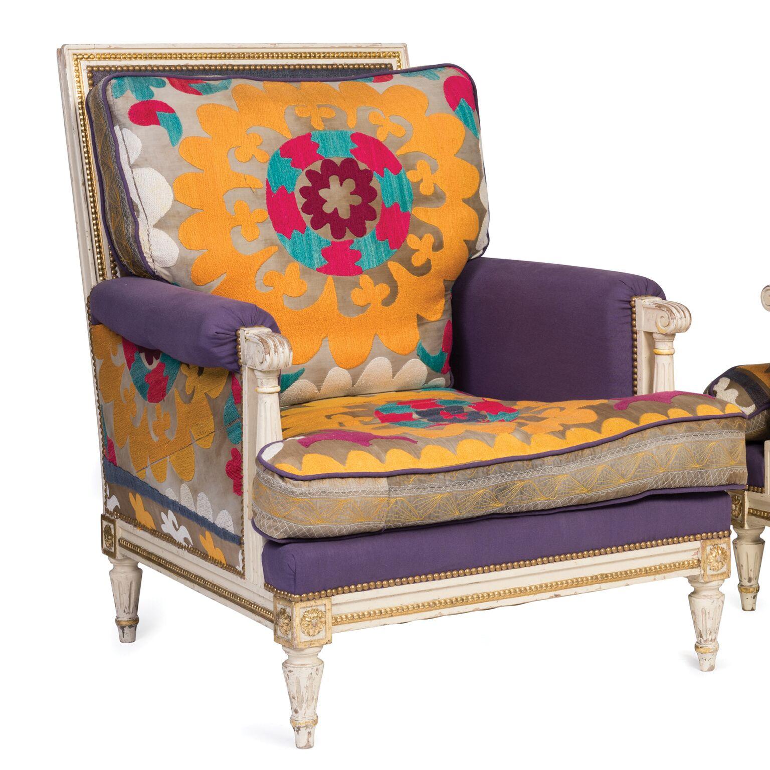 An exceptional pair of white and gilt decorated Louis XVI style armchairs, 
French, 19th century upholstered in striking gold, purple and cerise Uzbek tapestry.

Measures: 92 cm high, 78 cm wide, 88 cm deep.

These are fabulous chairs, both