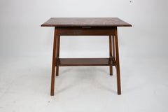 Arts & Crafts side table with oblong chequered inlaid top & curved aprons below.