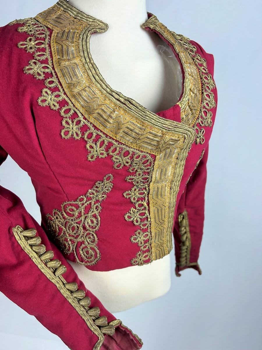 Second half of the 19th century
Ottoman Empire

A Caraco, a women's jacket in scarlet wool felt with gold embroidery. Fitted at the waist, with long sleeves and a large heart-shaped neckline. Beautiful embroidery of braids and applied gold cords