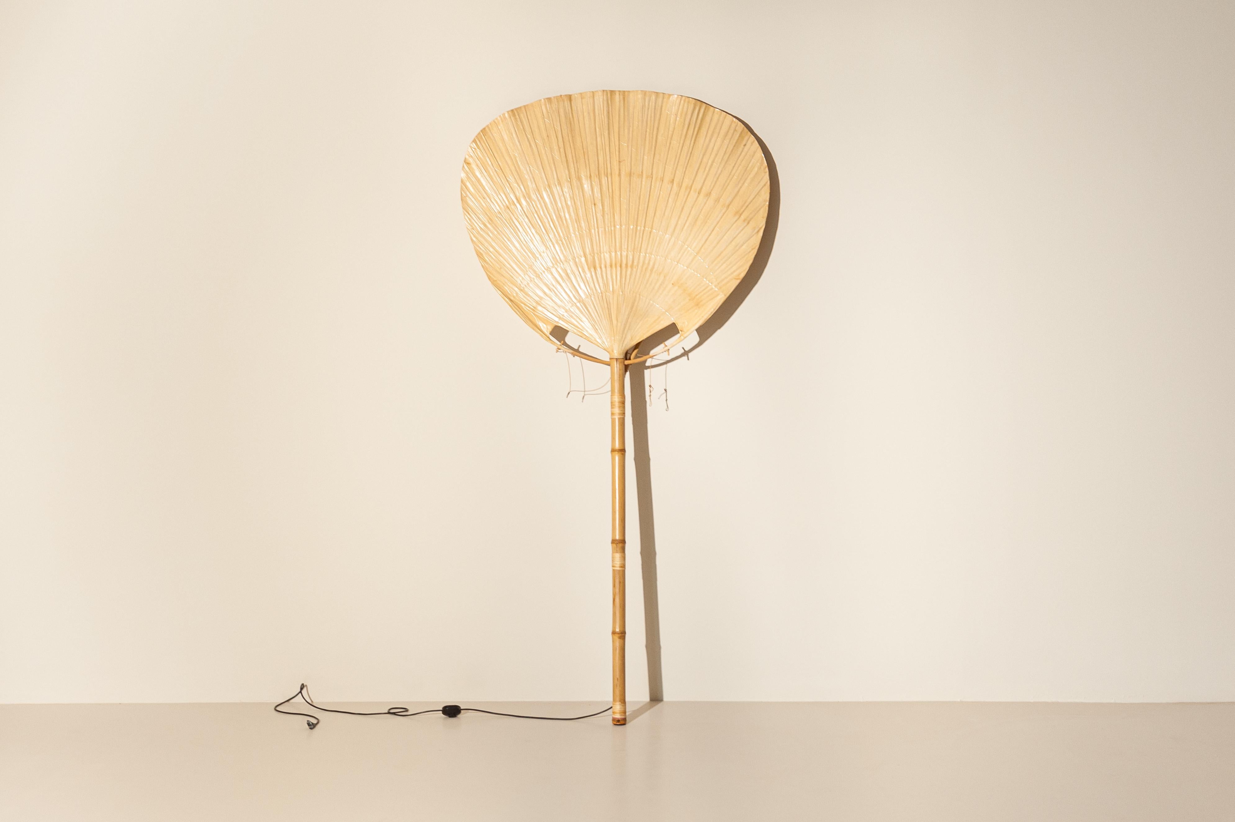 Large and rare Uchiwa bamboo floor lamp or wall lamp by Ingo Maurer for Design M, 1970s, Germany. 

Ingo Maurer's interest in rice paper for lampshades brought him to design and produce various models inspired by traditional Japanese fans during the