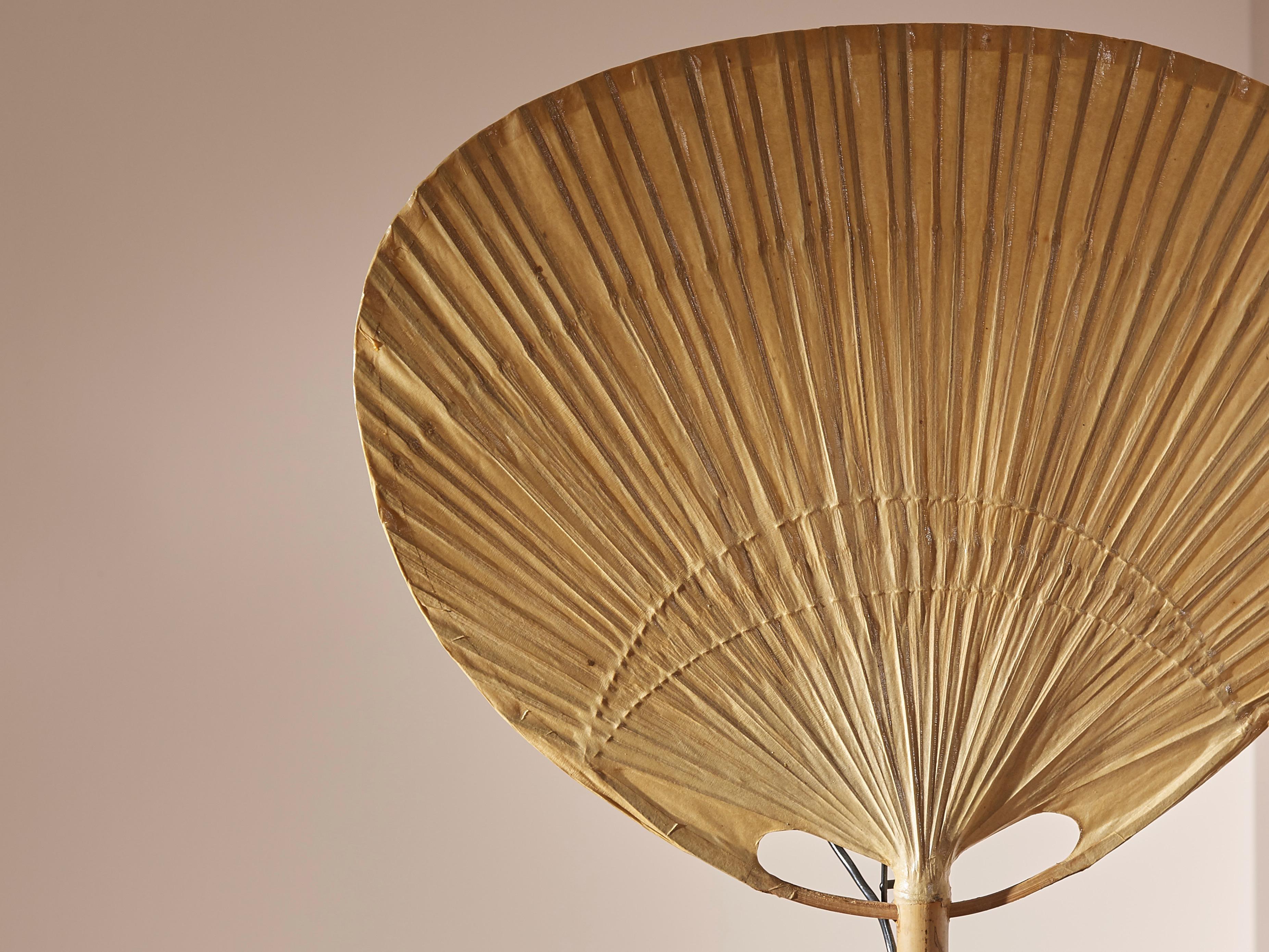 A rare Uchiwa bamboo table lamp or wall lamp by Ingo Maurer for Design M, 1970s, Germany.

Ingo Maurer's interest in rice paper for lampshades brought him to design and produce various models inspired by traditional Japanese fans during the