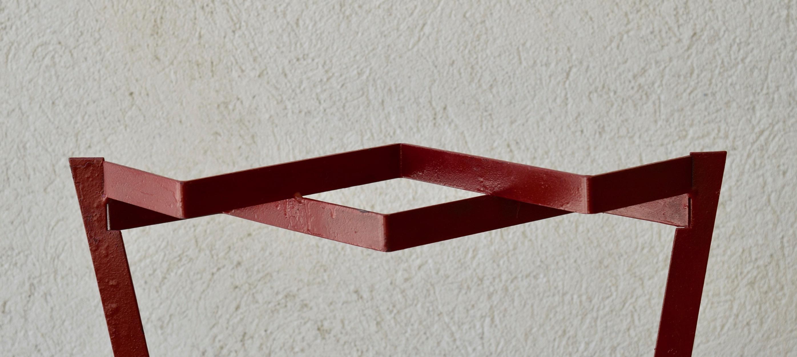 A red lacquered metal umbrella stand. Stone base, France, 1950s