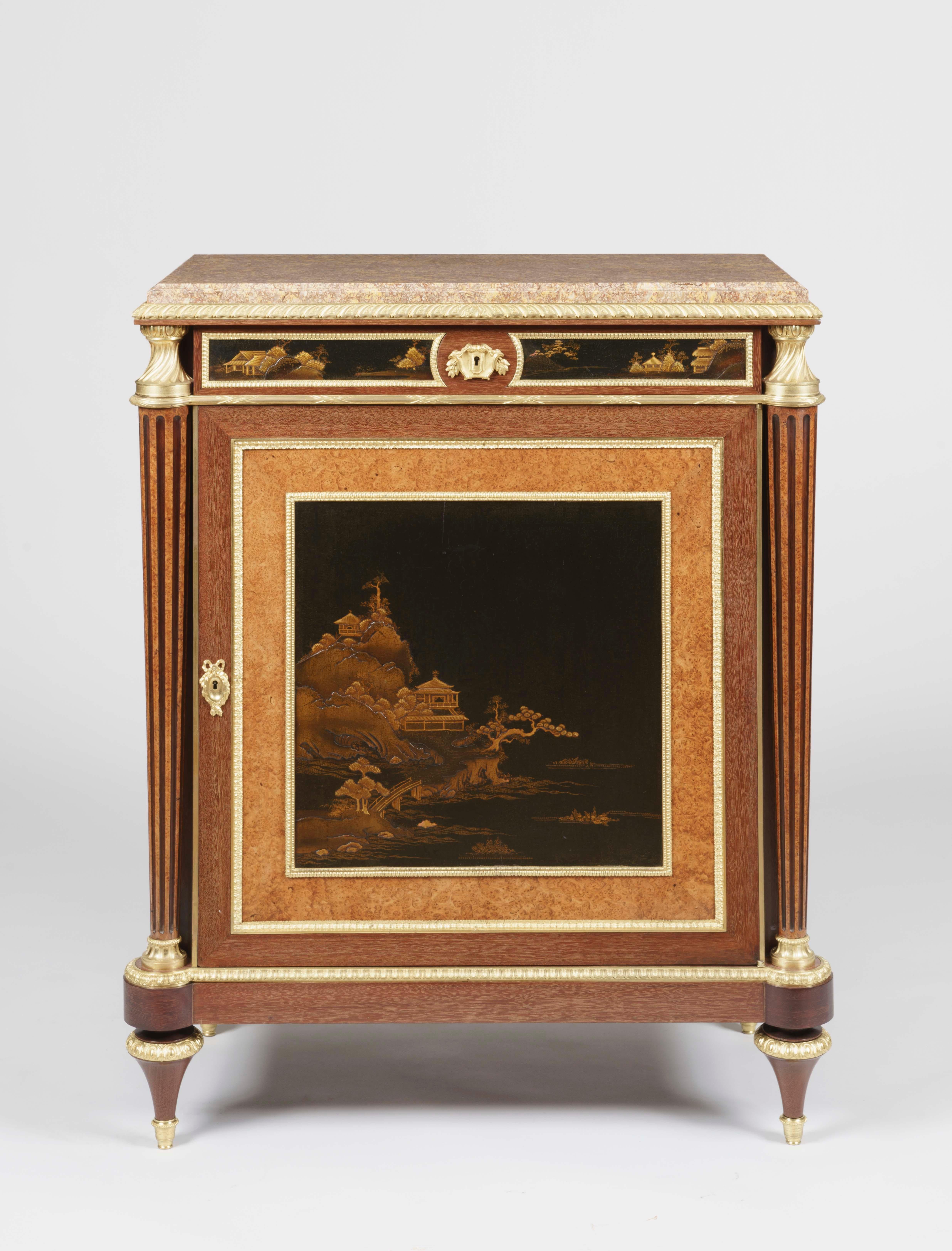 A Fine Pair of Cabinets
 by Henry Dasson

Constructed in amaranth and amboyna, and dressed with high quality ormolu bronze mounts, and Verdun Breccia marble platforms; rising from tapering cylindrical toupie feet supporting rectangular plinths