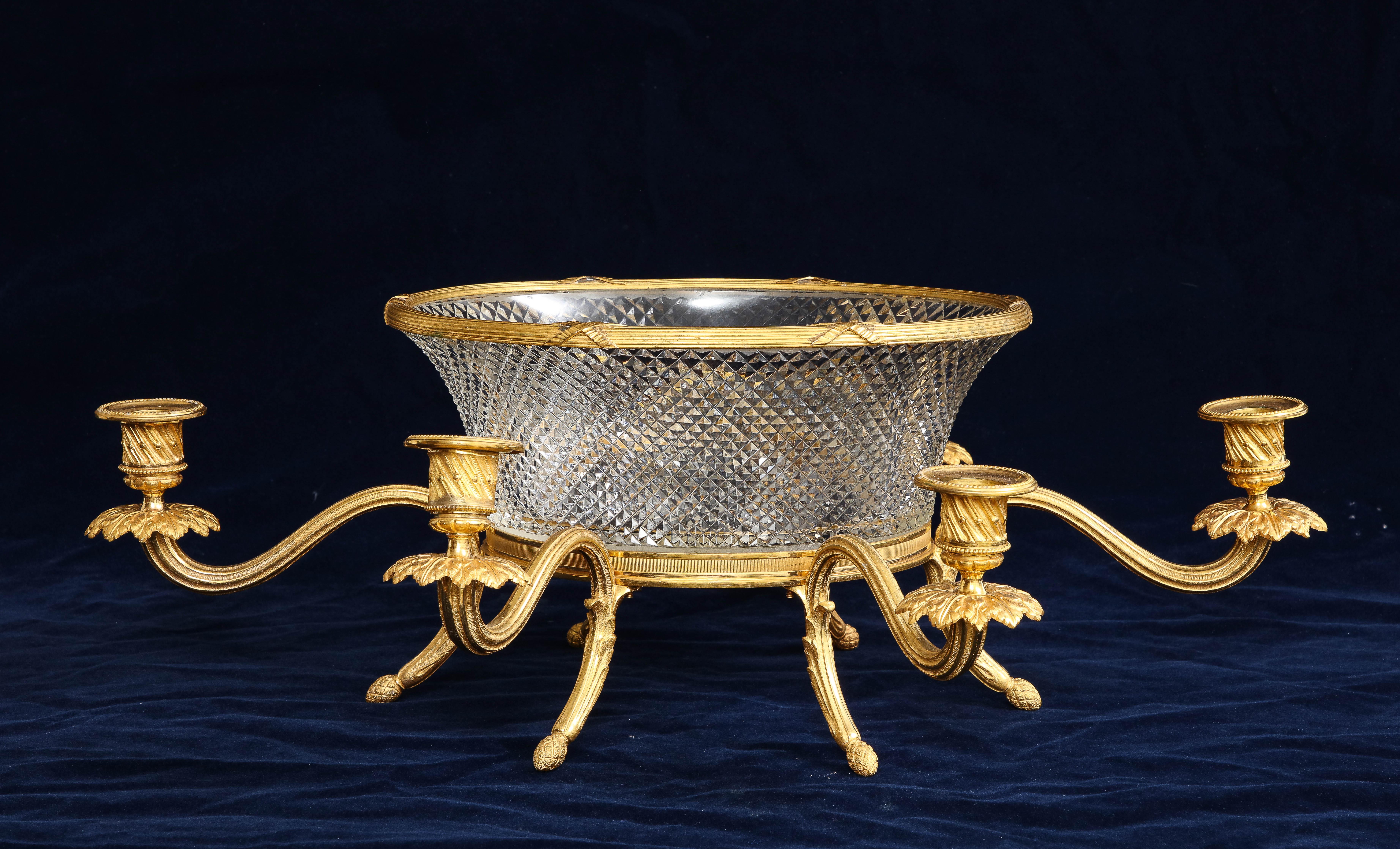 An unusual 19th century French ormolu mounted crystal centerpiece or candelabra, the crystal attributed to Baccarat. The crystal bowl has a beautiful prismic pattern which has been handcut. The crystal is further mounted on a gorgeous hand-chased