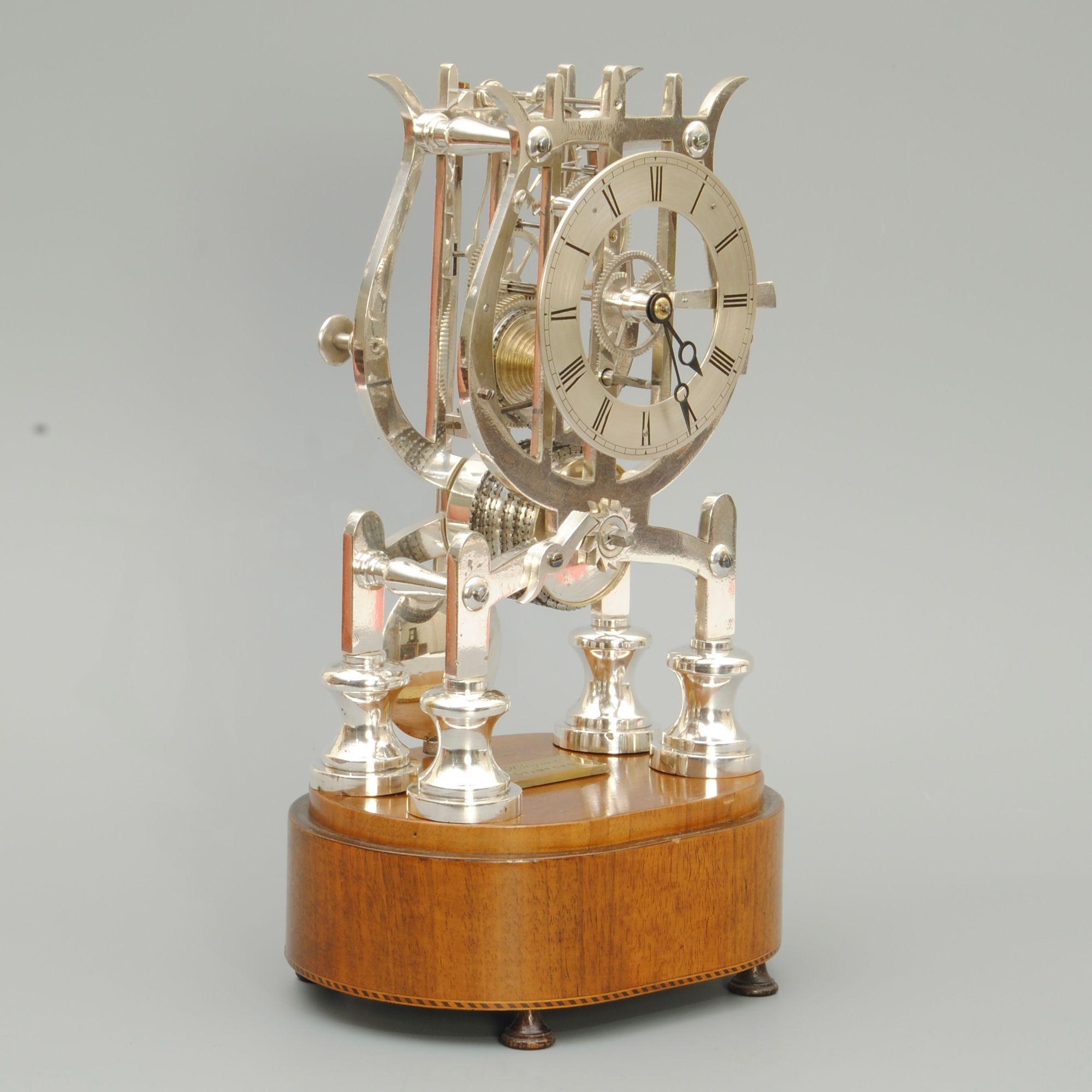 A super lyre-shaped mid 19th century skeleton clock by Haynes of Stamford, with the original mahogany base having an engraved makers plaque, with the origial glass dome.
This is a fine quality and unusual clock been silvered rather than lacquered