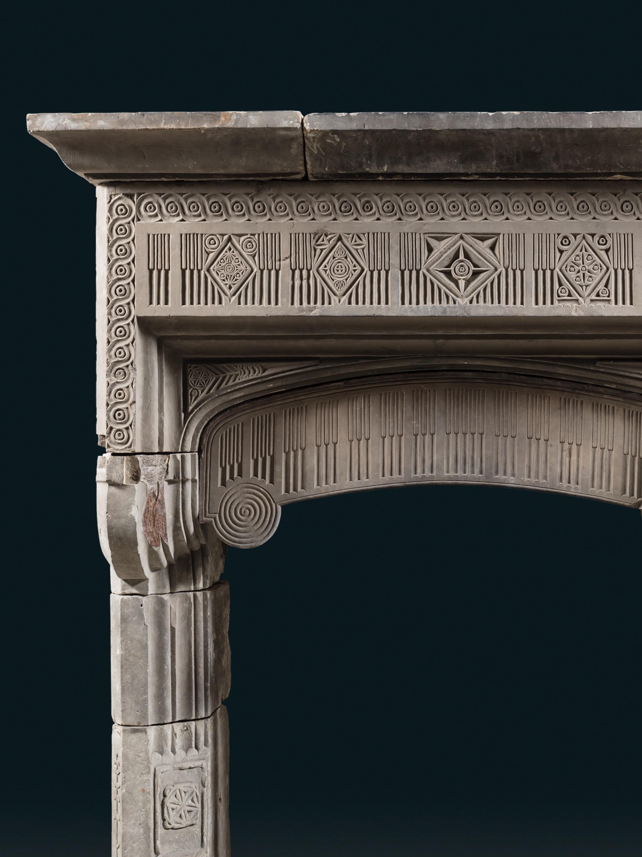 Most likely a product of the late Elizabethan period (1558–1603). Beneath the uncarved shelf in three blocks, guilloche is carved into the stone, framing the frieze, which is carved with asymmetrical ornamentation of alternating geometric designs