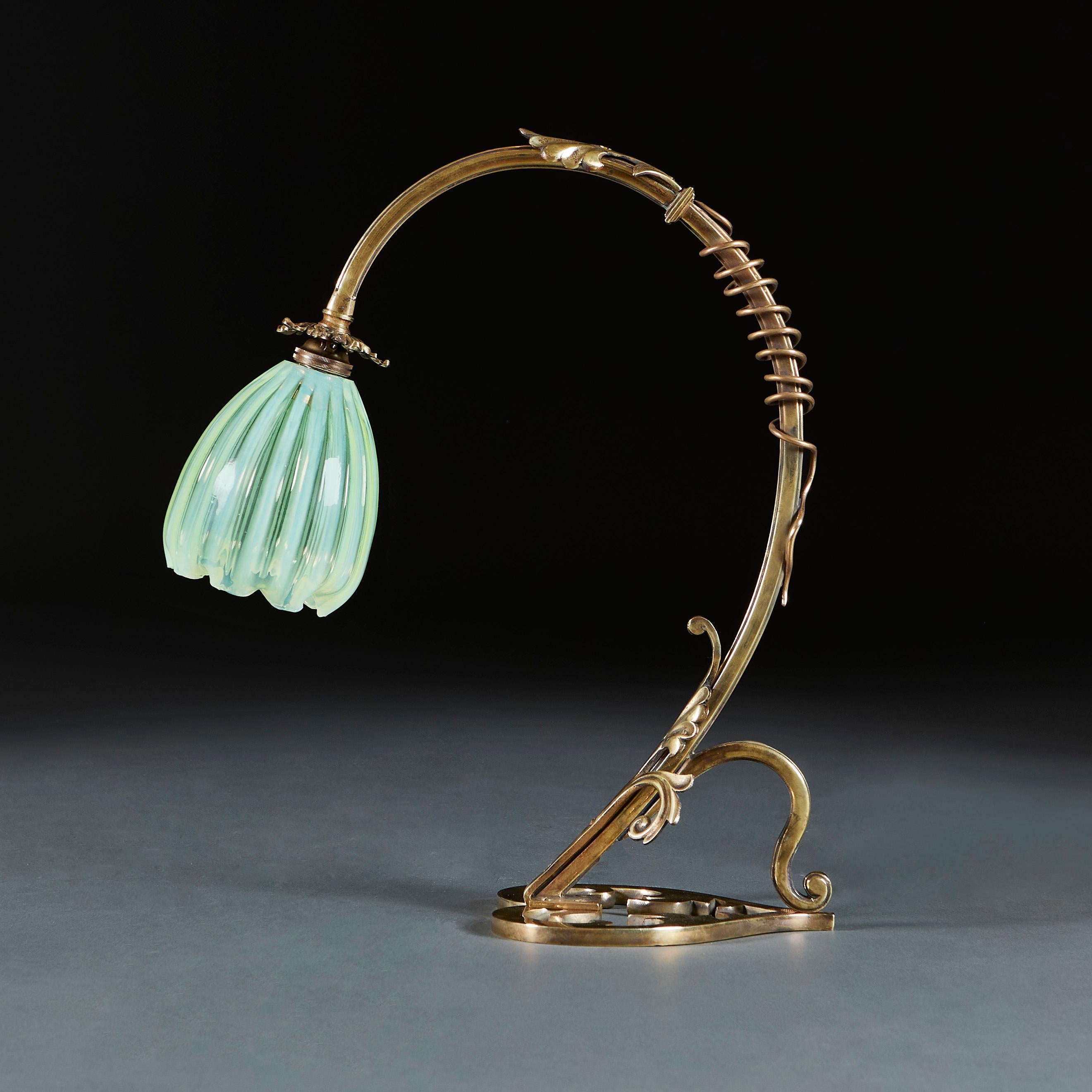 England, circa 1900

An unusual brass lamp with curved neck wrapped with scrolling vine, the heart shape base pierced with foliate form, with original opaline glass shade.

Height 42.00cm
Width 36.00cm
Depth 17.00cm

Please note: This is currently