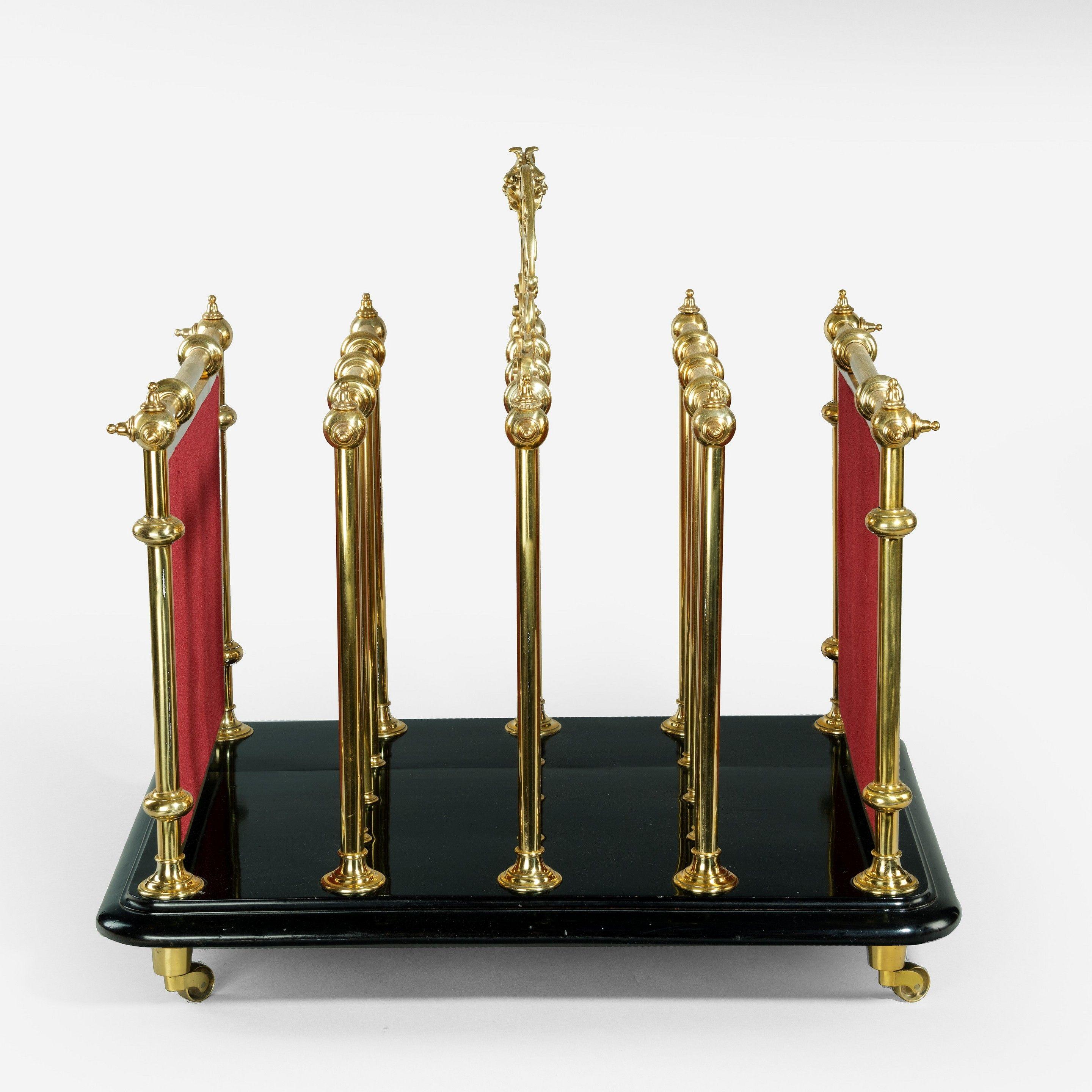 An unusual Victorian brass music Canterbury, of rectangular form with four compartments divided by knopped brass frames, the central one surmounted by an ornate openwork carrying handle, the solid ends applied with engraved, openwork lyres on