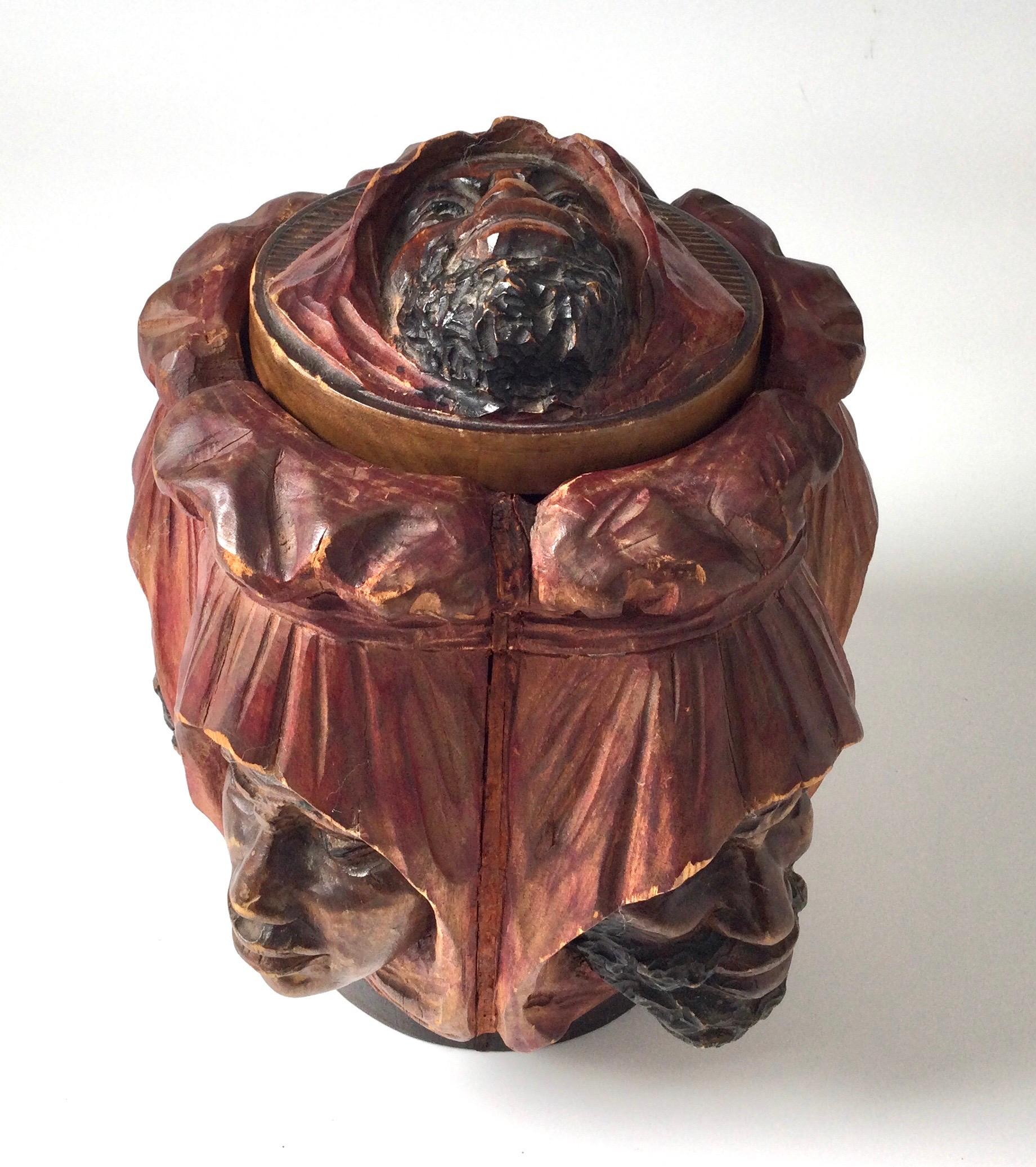 Unusual Hand Carved Hardwood and Polychromed Humidor With Six Nomadic Figures
An early 20th century hand carved humidor with lid. The top and body with detailed faces of nomadic men. The main color is a deep burgundy red with hand painted scarves on