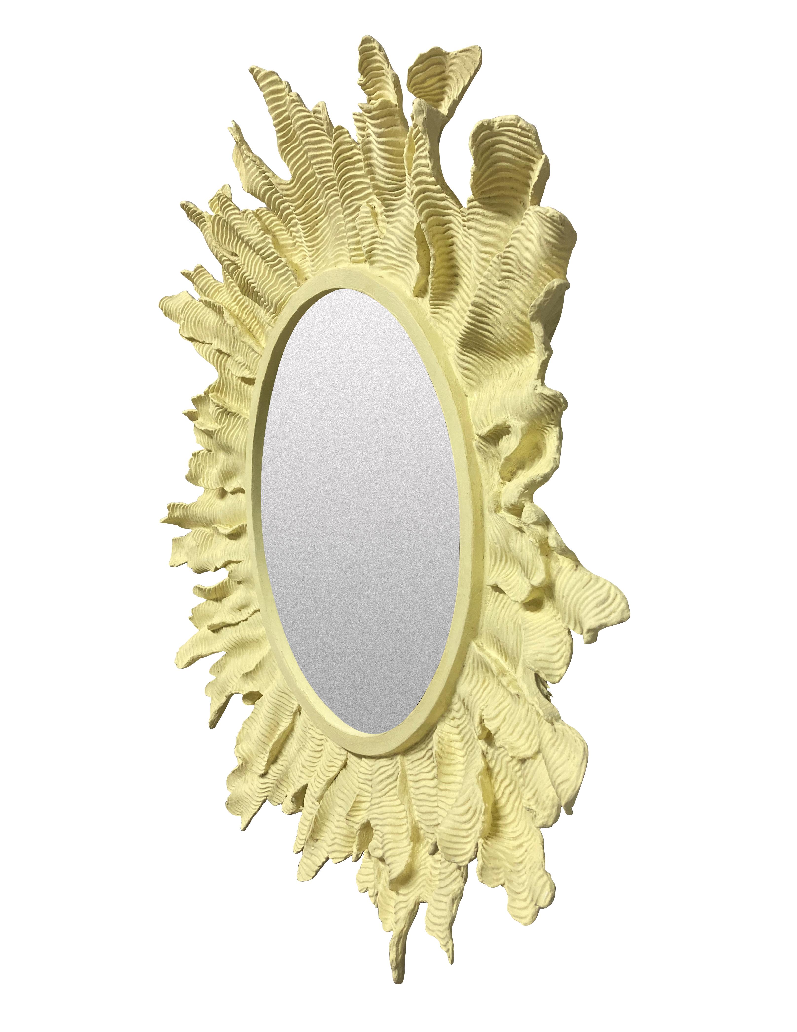 An unusual French sunburst mirror, of tactile design. In pale yellow painted fibreglass, with a circular plate.