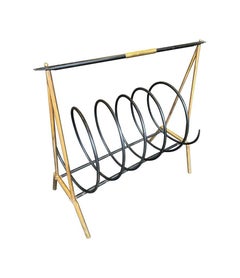 An unusual Italian 1950s brass and black lacquered spiral magazine rack