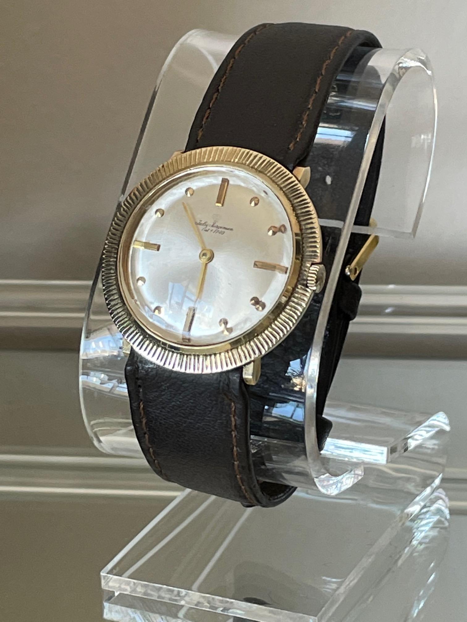 An unusual and early 1970s high style Jules Jurgensen wristwatch. Mechanical wind complete with original box, guarantee and hang tag-a real time warp. Unusual case in 14-karat yellow gold features a beautiful Brutalist style coin edge and recessed