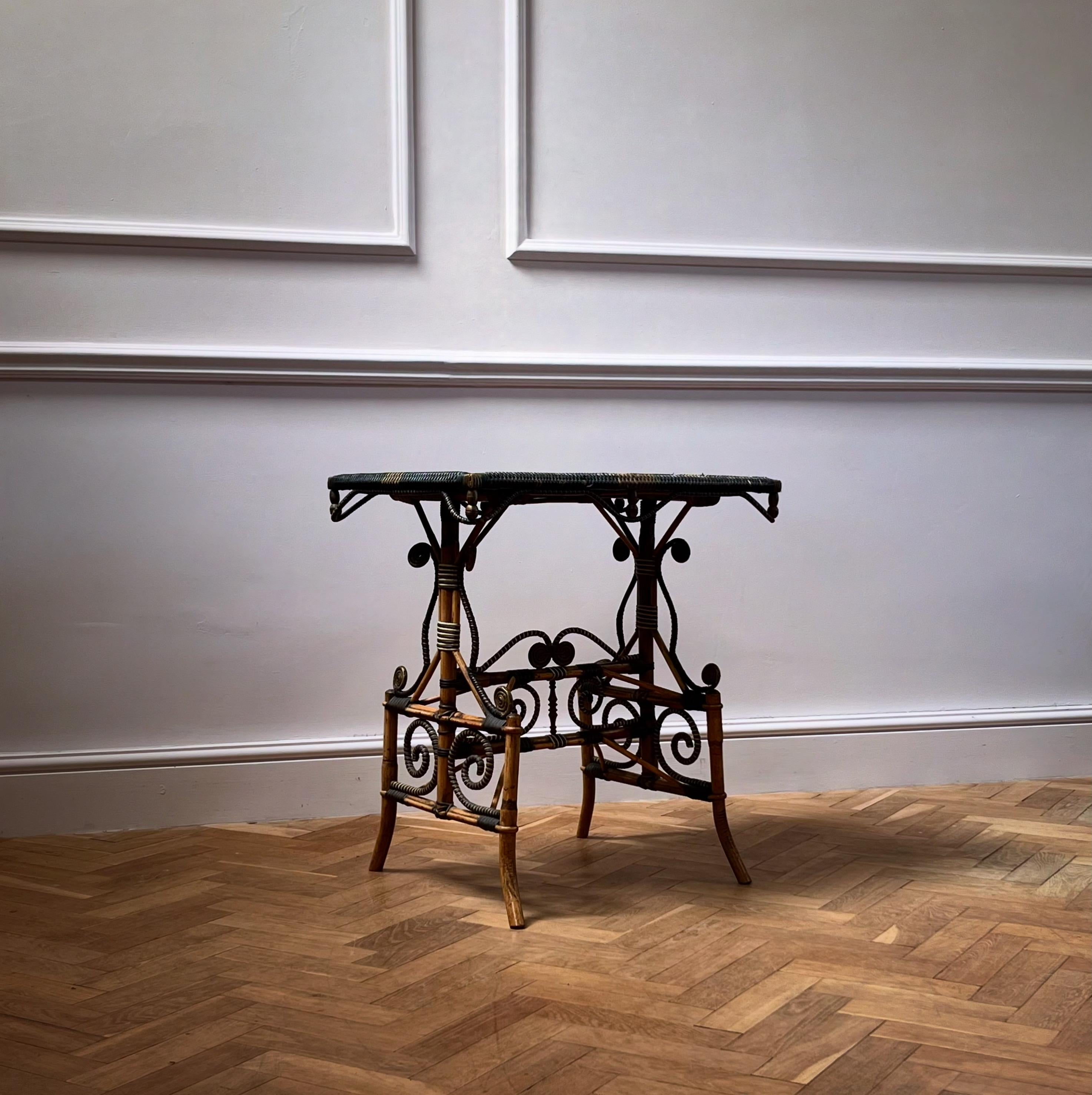A most unusual side table with bamboo substructure adorned with wicker volutes and scrolls, the rectangular top with Japanese lacquer top decorated with birds and floral patterns 

Japanese Export, Late Nineteenth Century

H 70 x W 66 x D 46 cms 
