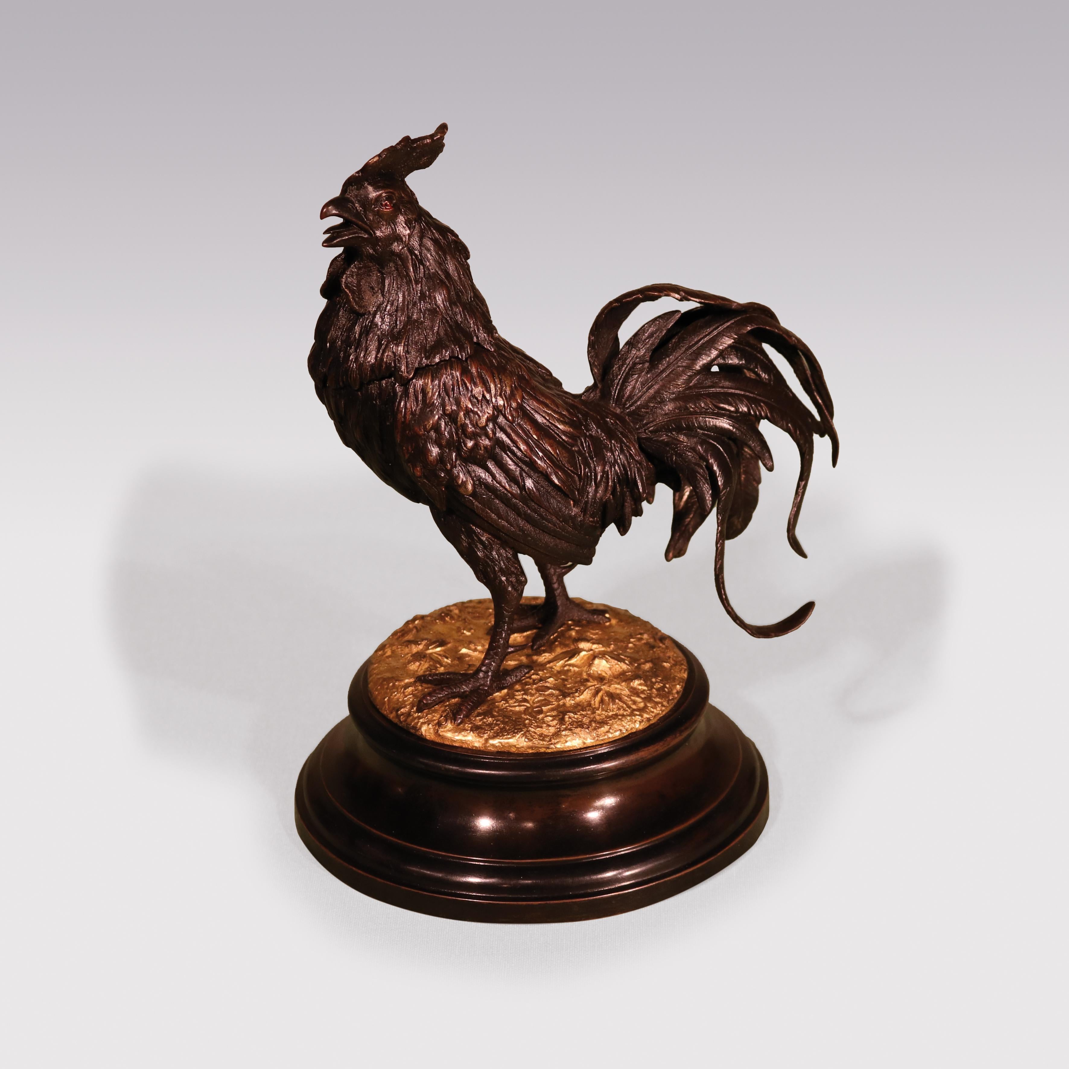 An unusual mid 19th Century bronze & ormolu Inkwell in the form of well-cast Cockerel with lifting head, spurs and flamboyant tail feathers, raised on moulded socle.