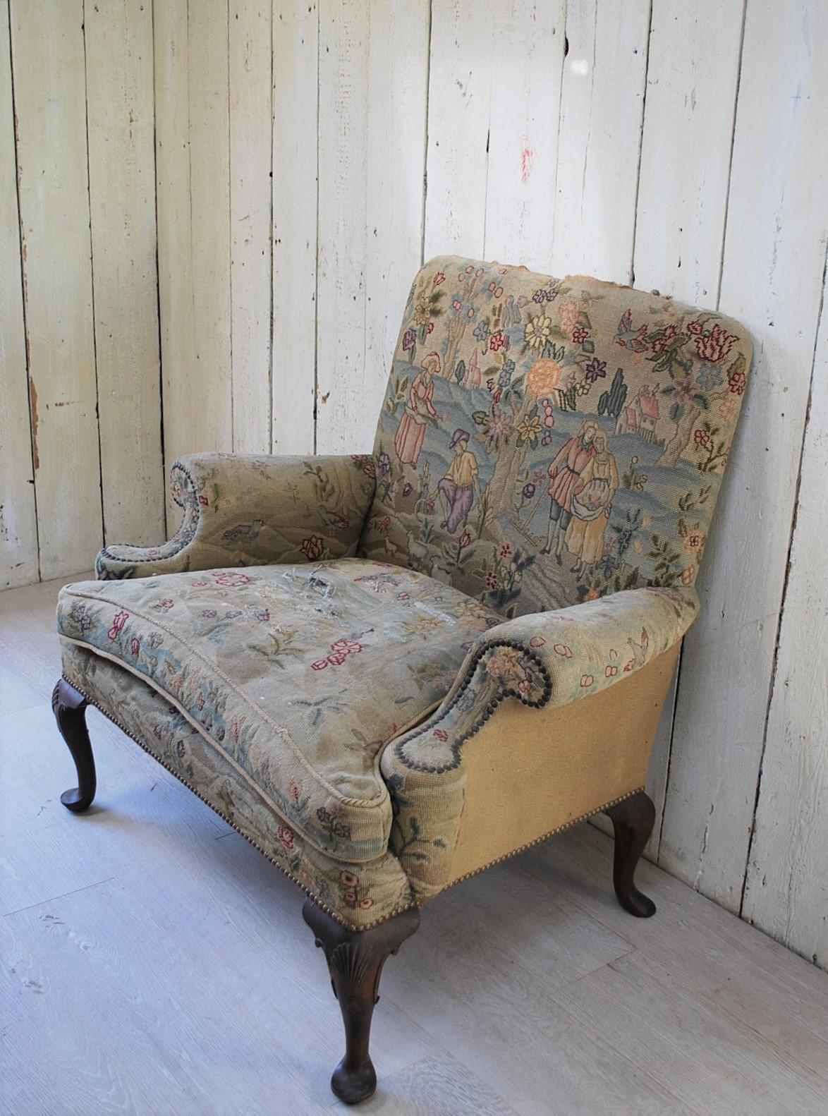 A rare and unusual oversized Queen Anne style wing chair, with an old worn tapestry. A real country house statement piece, that looks very authentic. Extremely rare to find a good copy that is true to the original design with good lines. Standing on