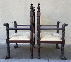 An unusual pair of American Empire classic carved mahogany armchairs.