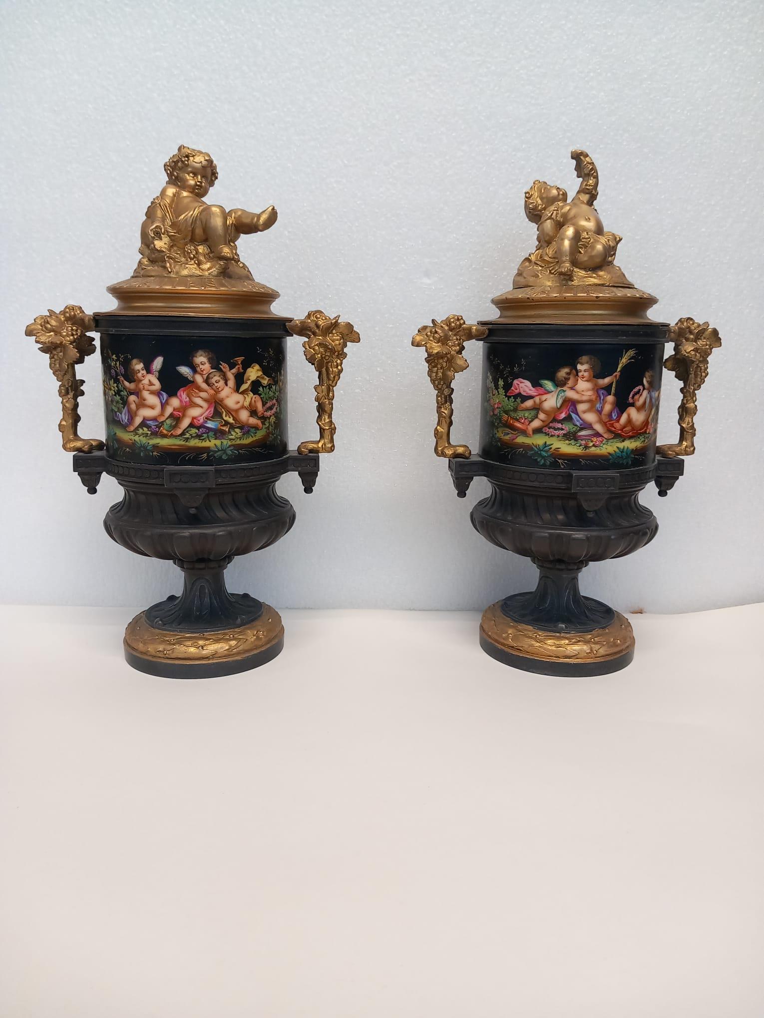 Gilt An unusual pair of  French vases hand painted in bright enamel colours For Sale
