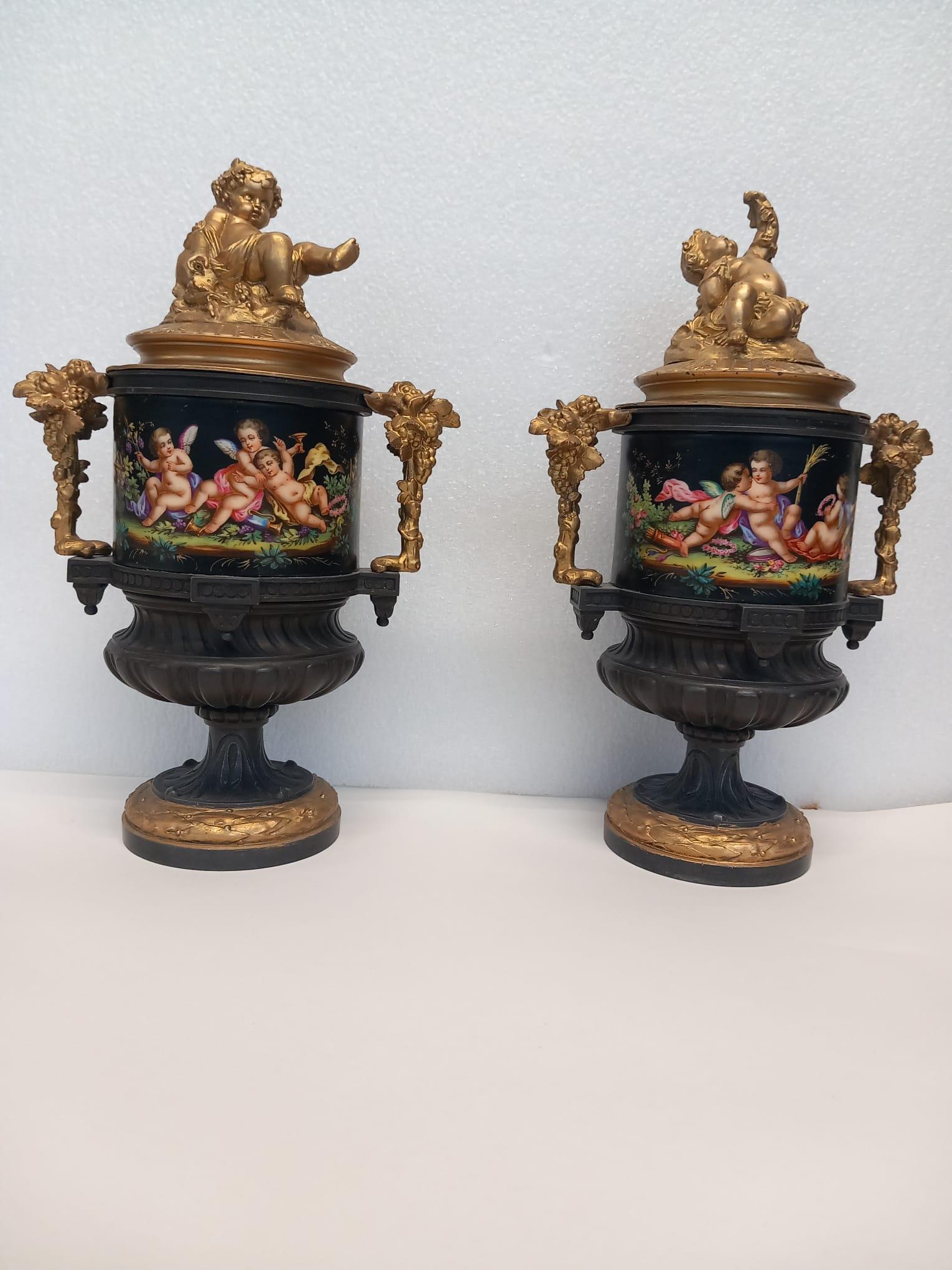 Bronze An unusual pair of  French vases hand painted in bright enamel colours For Sale