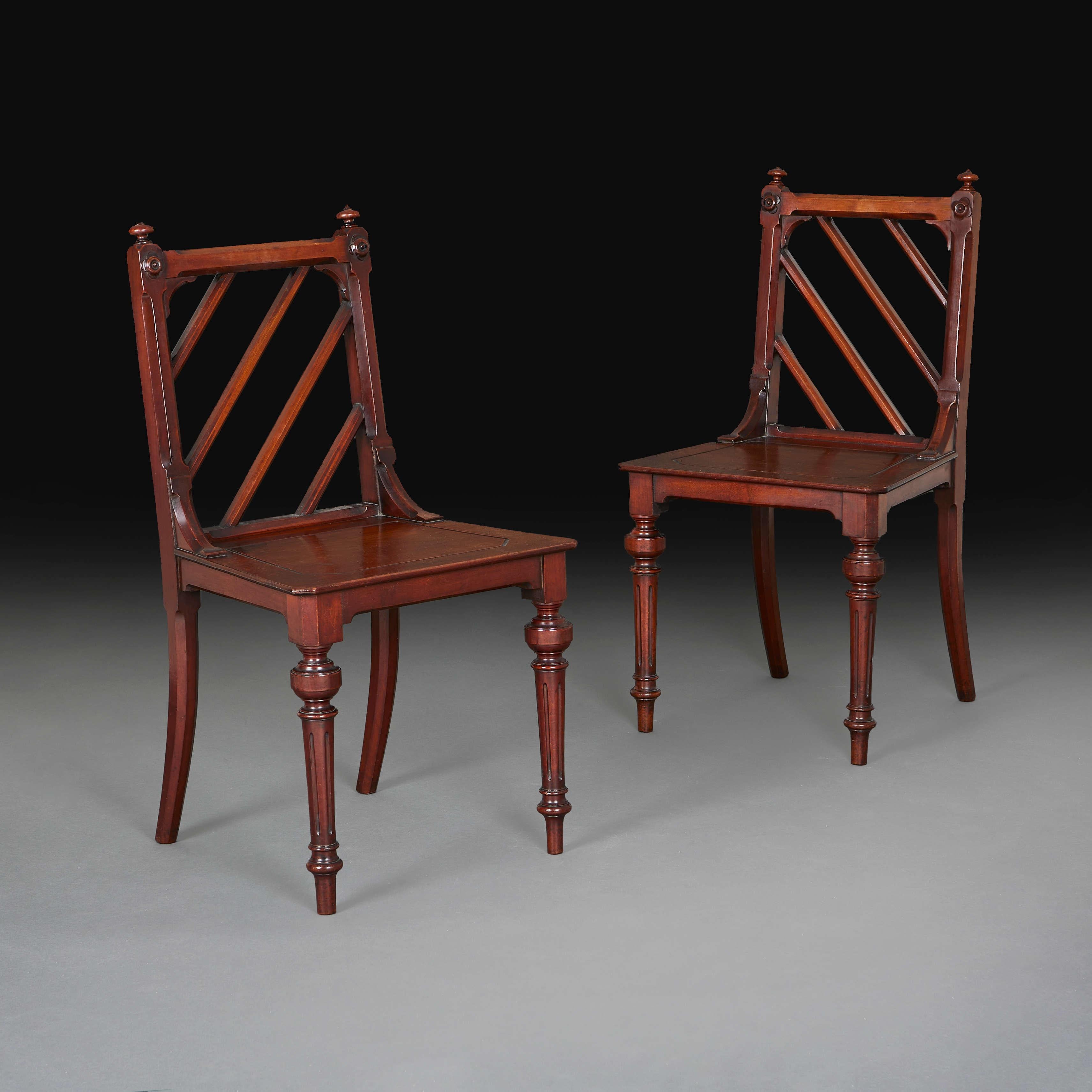 England, circa 1850

An unusual pair of mid-nineteenth century mahogany hall chairs with diagonal back splats in Chinese taste, square seats, all supported on turned legs.

Height 79.5 cm.

Width 45 cm.

Depth 42 cm.