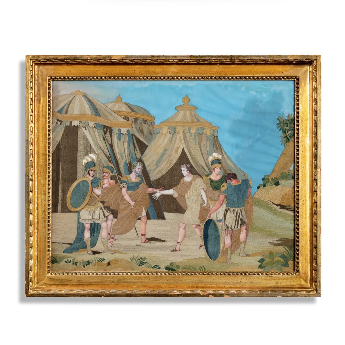 An unusual pair of Italian silk embroidery and gouache painted paper pictures, both with scenes from Classical antiquity, one showing two warriors addressing an old man by a cave, the other with two men greeting each other in front of a tented