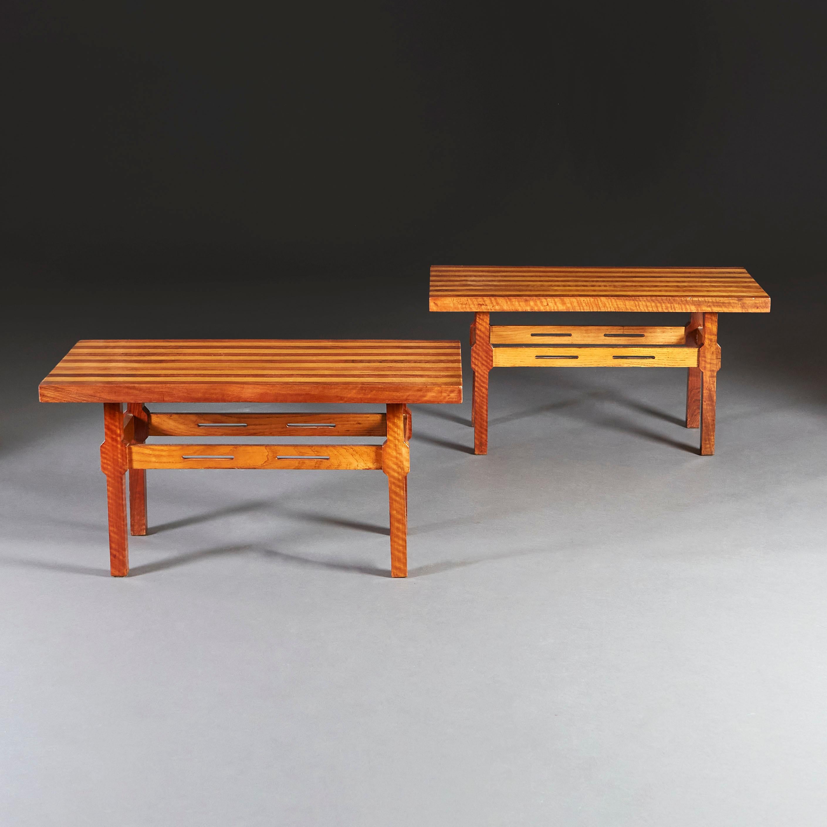 A pair of 1970s Italian occasional tables of rectangular form, with two tone striped tops, the bases with pierced stretchers between the four supporting legs.