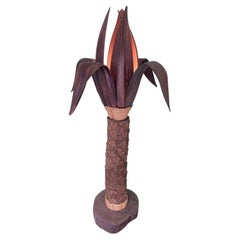 An unusual palm tree floor lamp with real palm trunk wooden base shaped leaves
