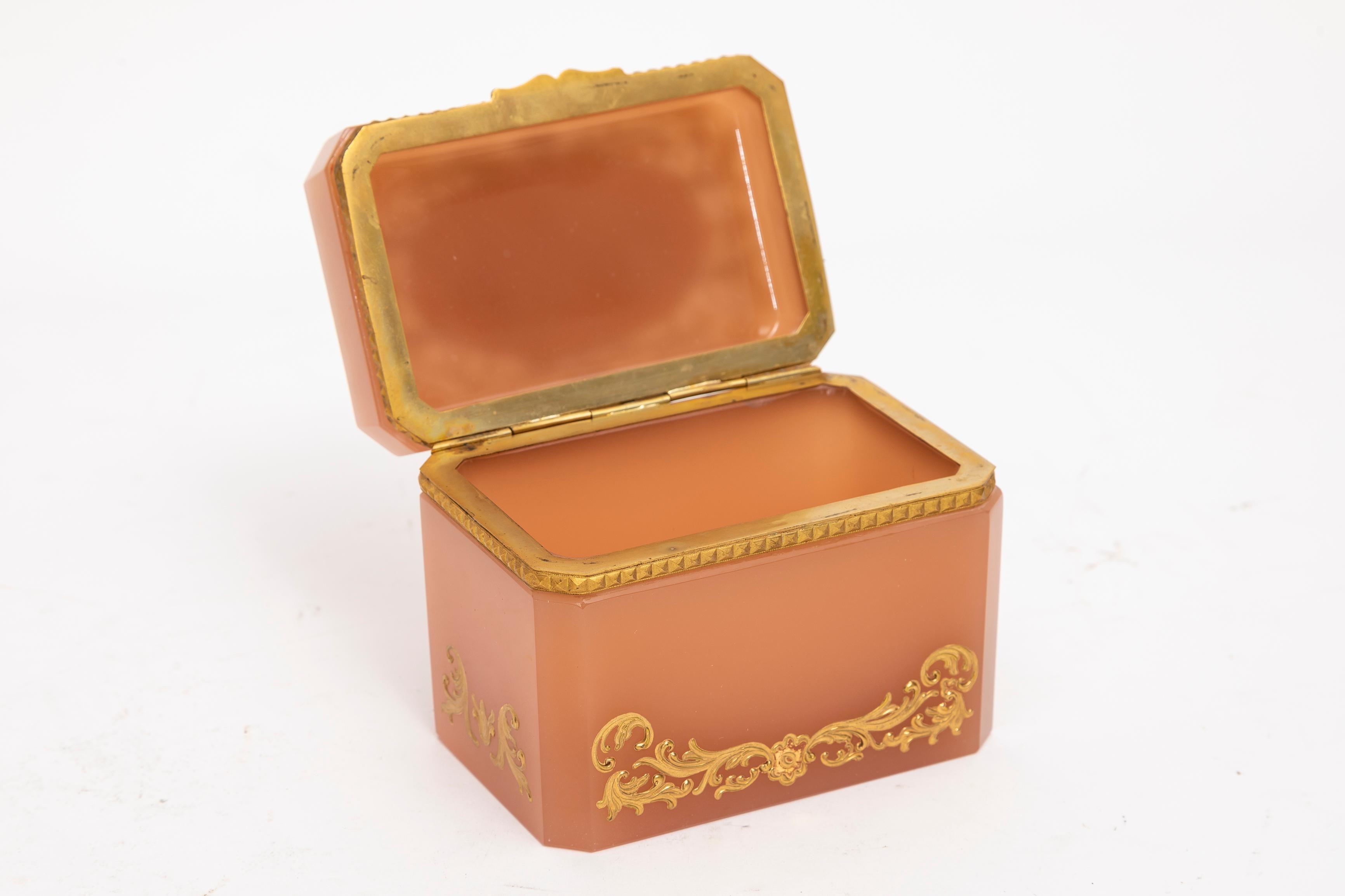 An Unusual Peach Opaline Dore Bronze Mounted Hinged Box by Moser with Raised Gold Decoration and Floral Enamel Decoration. Opaline of this quality and color is truly difficult to find. Each section of this crystal box has been carefully hand-diamond