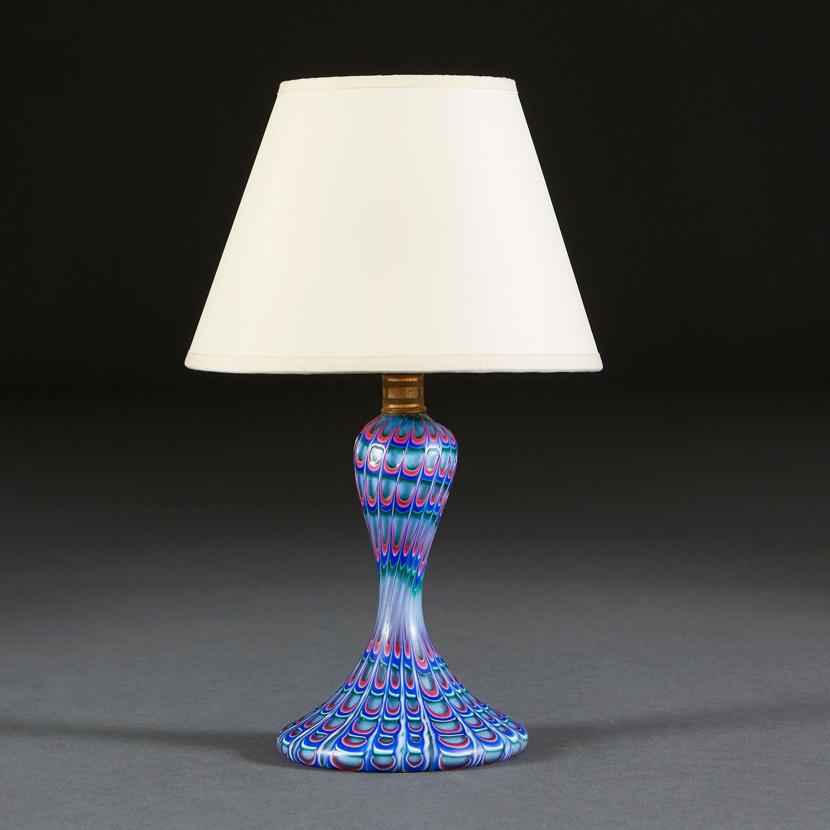 An unusual Murano glass lamp by Seguso, of small scale, with blue and pink drip swirl pattern to the surface imitating the feathers of a peacock.

Currently wired for the UK.

Please note: Lampshade not included.