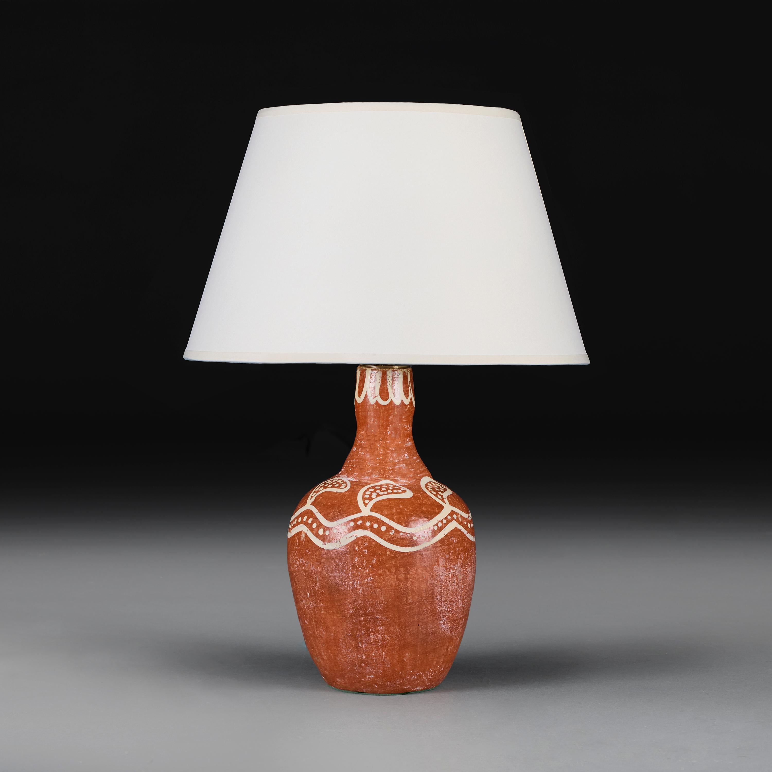 Peru, circa 1930.

An early twentieth century Peruvian terracotta bottle form vase, with white decoration to the neck, now as a lamp.

Height 29.00 centimetres.
Height with shade 54.00 centimetres.
Diameter 17.00 centimetres.

Please