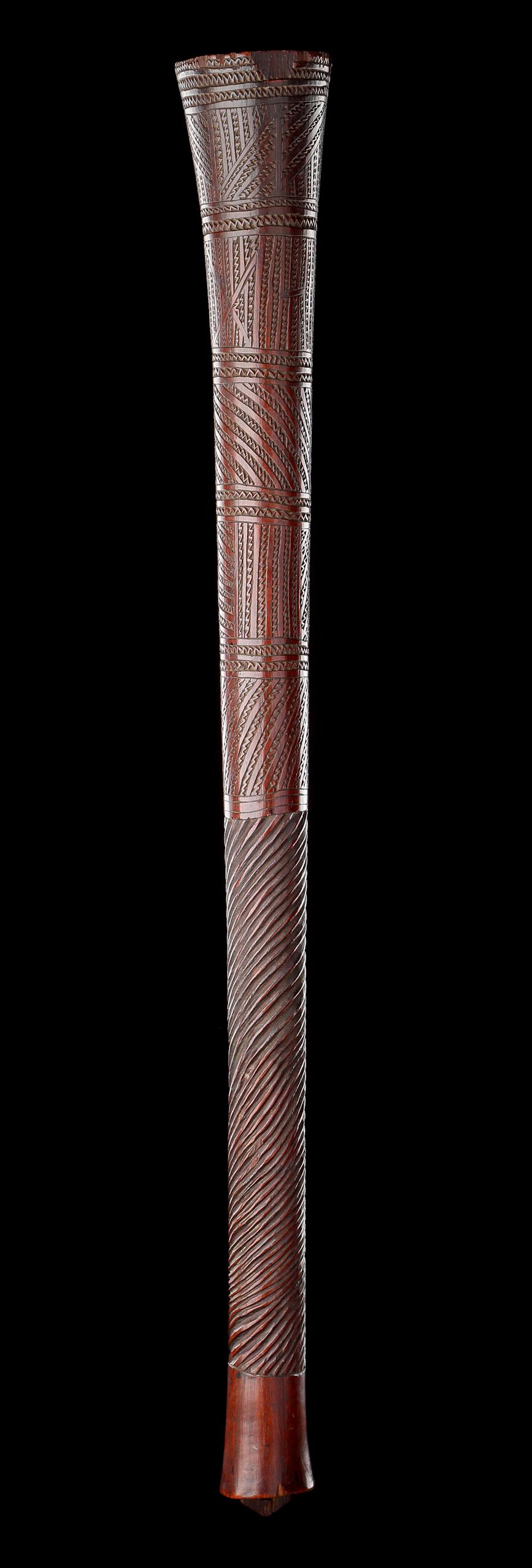 An Unusual Polynesian Fighting Club 
With a superb geometric upper section and unusual spiral twist grip 
Dark glossy patina and excellent colour, with a lug to the butt and ‘old’ paper label to the top
Wood
Tonga 
Early 19th Century 

Size: 77.5cm