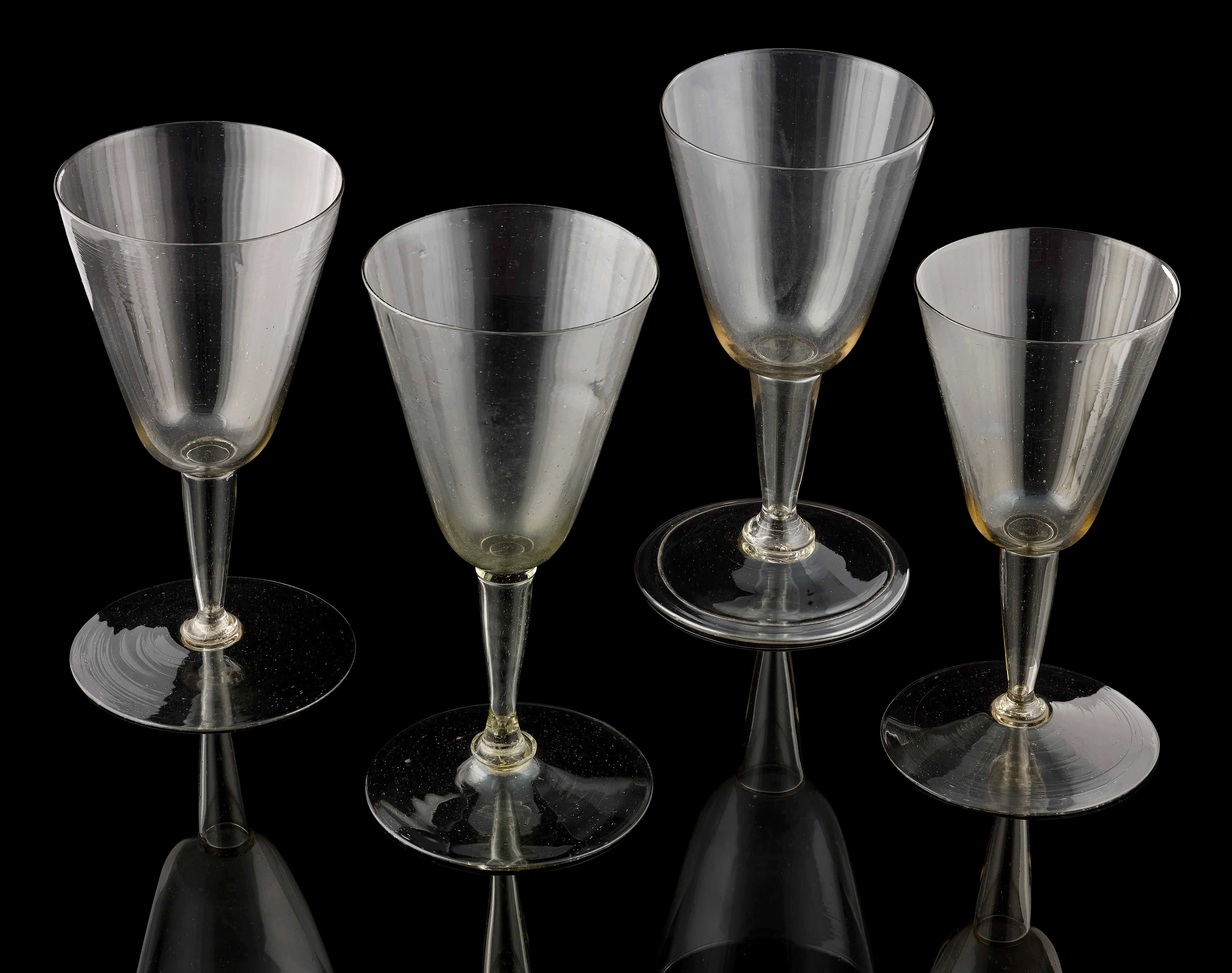 An unusual 'set' of 4 Cristallo glasses; Venetian, early 17th century; of slightly varying size, but all of similar design with a conical bowl over a hollow, conical stem; one with a folded foot, the others plain; the tallest is 15 cms high and the