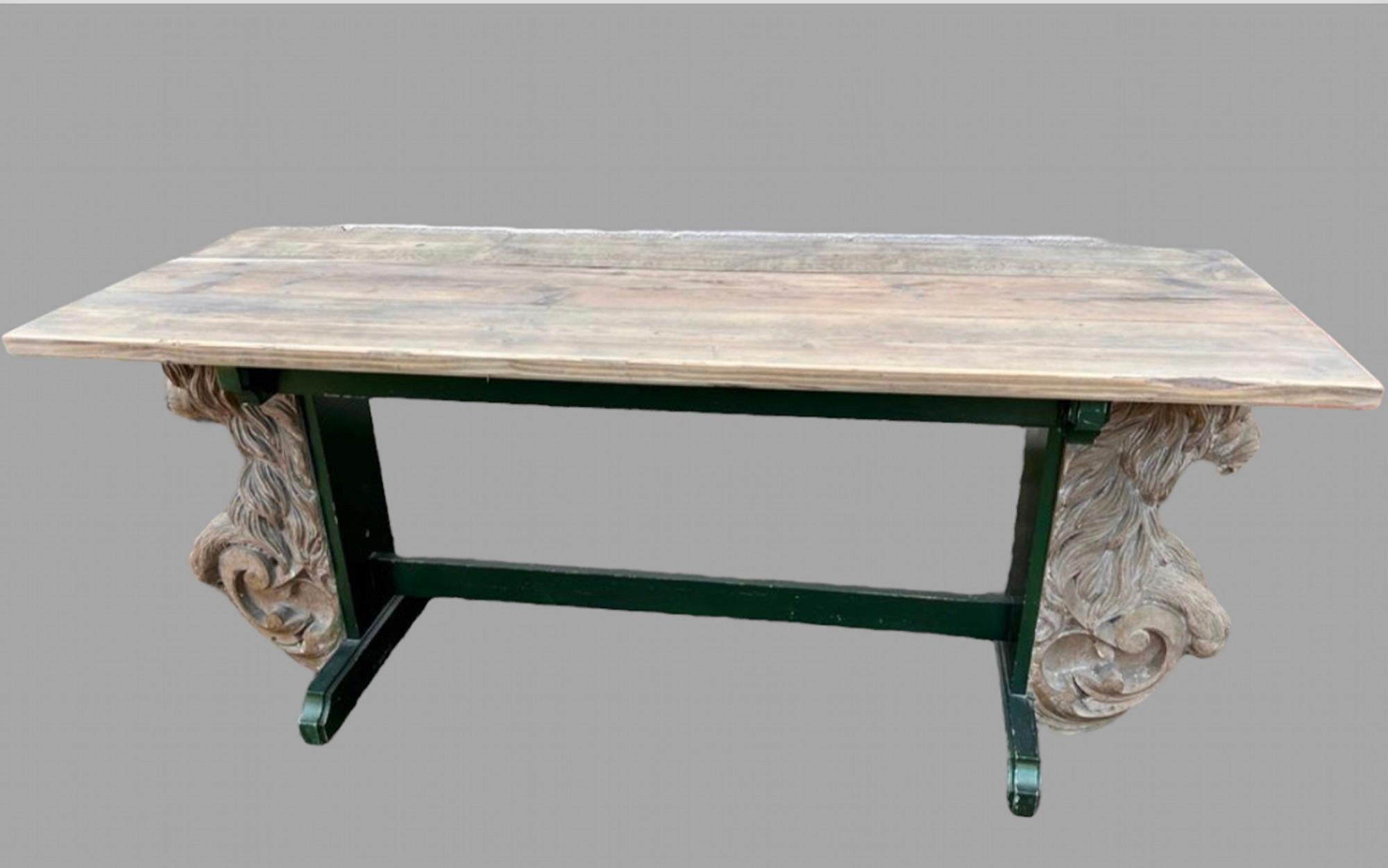 A 20th Century Trestle Table with resin lion supports either end and with a painted green wood frame showing some wear for multiple uses Hall Or Kitchen. The top comprises of three sealed and waxed planks . Seat 6/8 people.