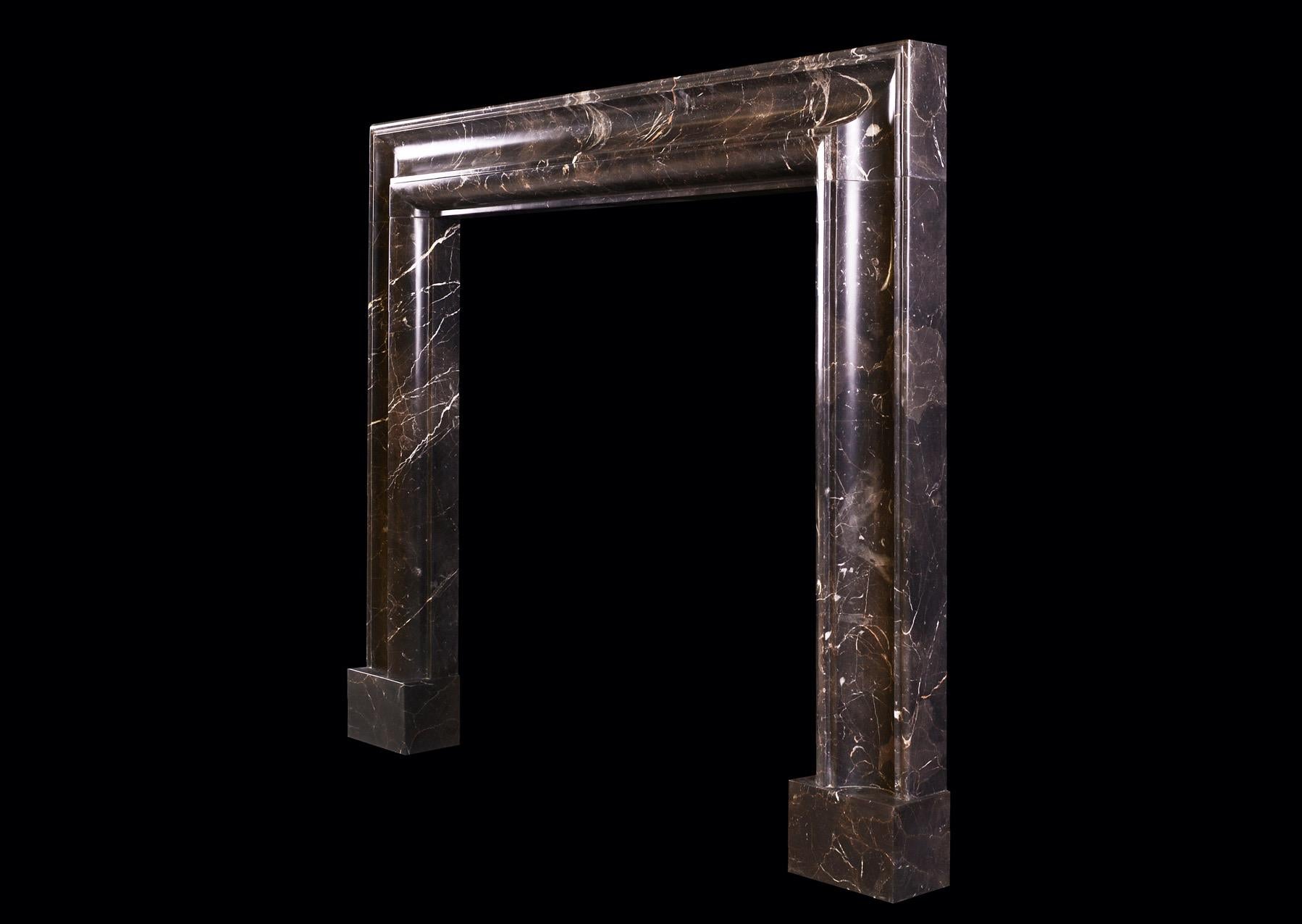 Unusually Shaped English Bolection Moulded Fireplace in Dark Emperador Marble In Good Condition For Sale In London, GB