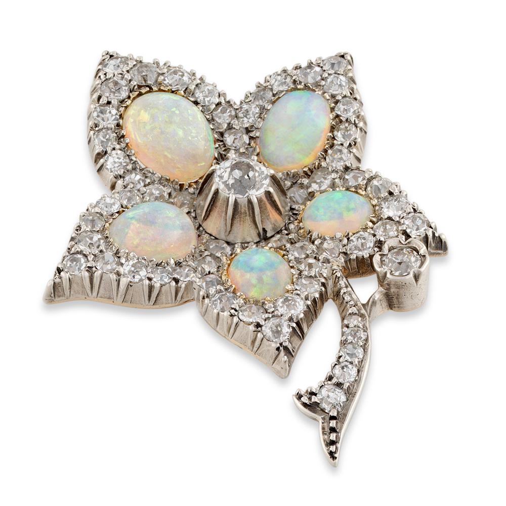 An Victorian opal and diamond flower brooch, with a central old brilliant-cut diamond in a silver collet and five petals each set at centre with an oval opal, surrounded by grain-set diamonds, the stem similarly set, all mounted in silver on a