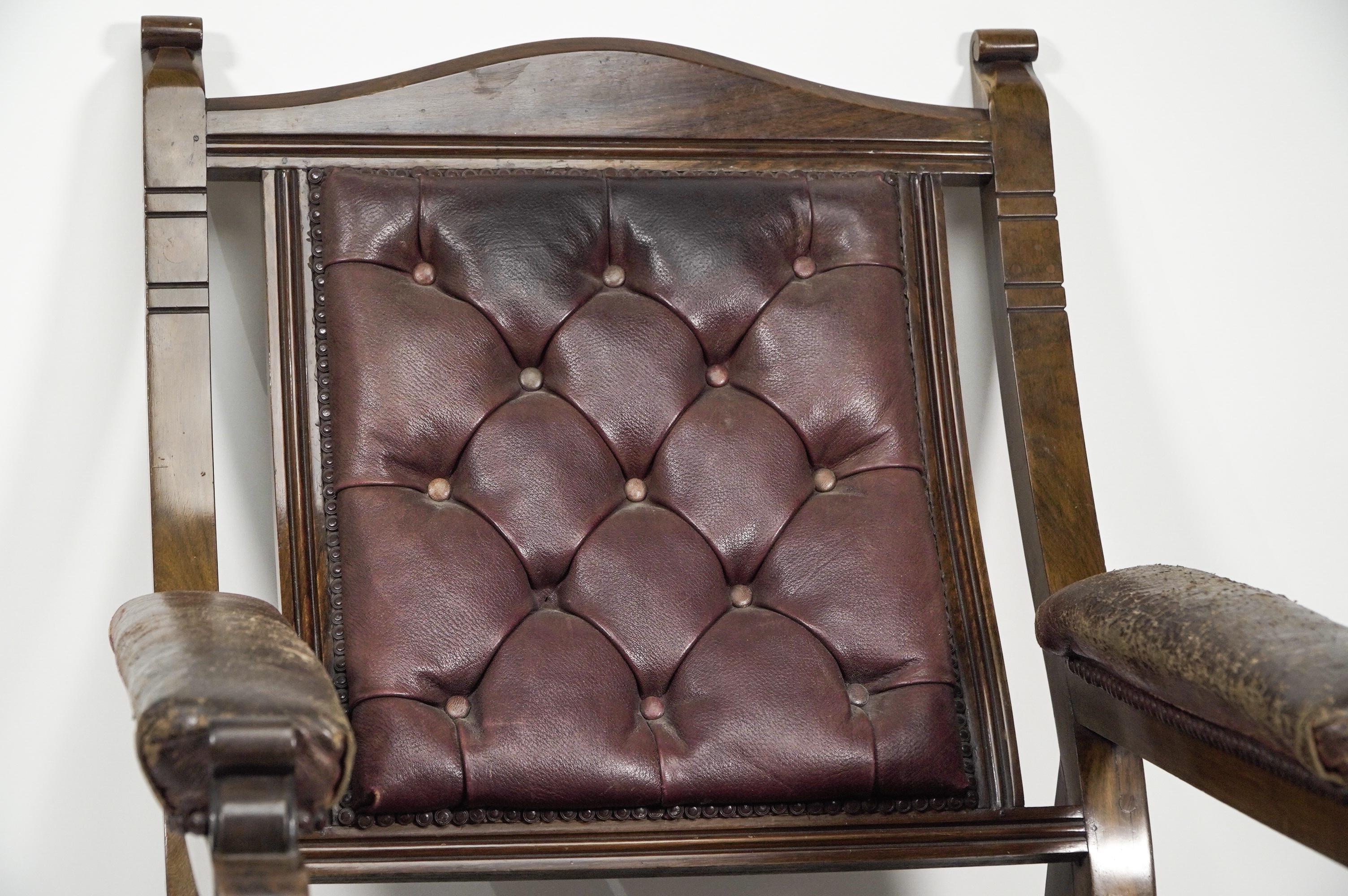 Late 19th Century An Aesthetic Movement walnut armchair with a curvaceous back leather upholstery. For Sale