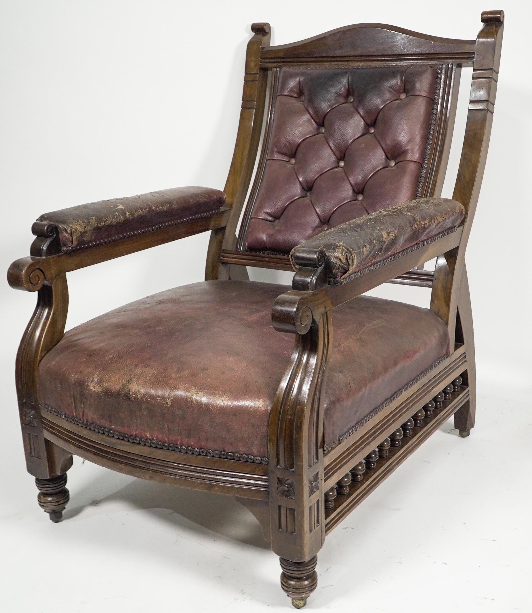 English An Aesthetic Movement walnut armchair with a curvaceous back leather upholstery. For Sale